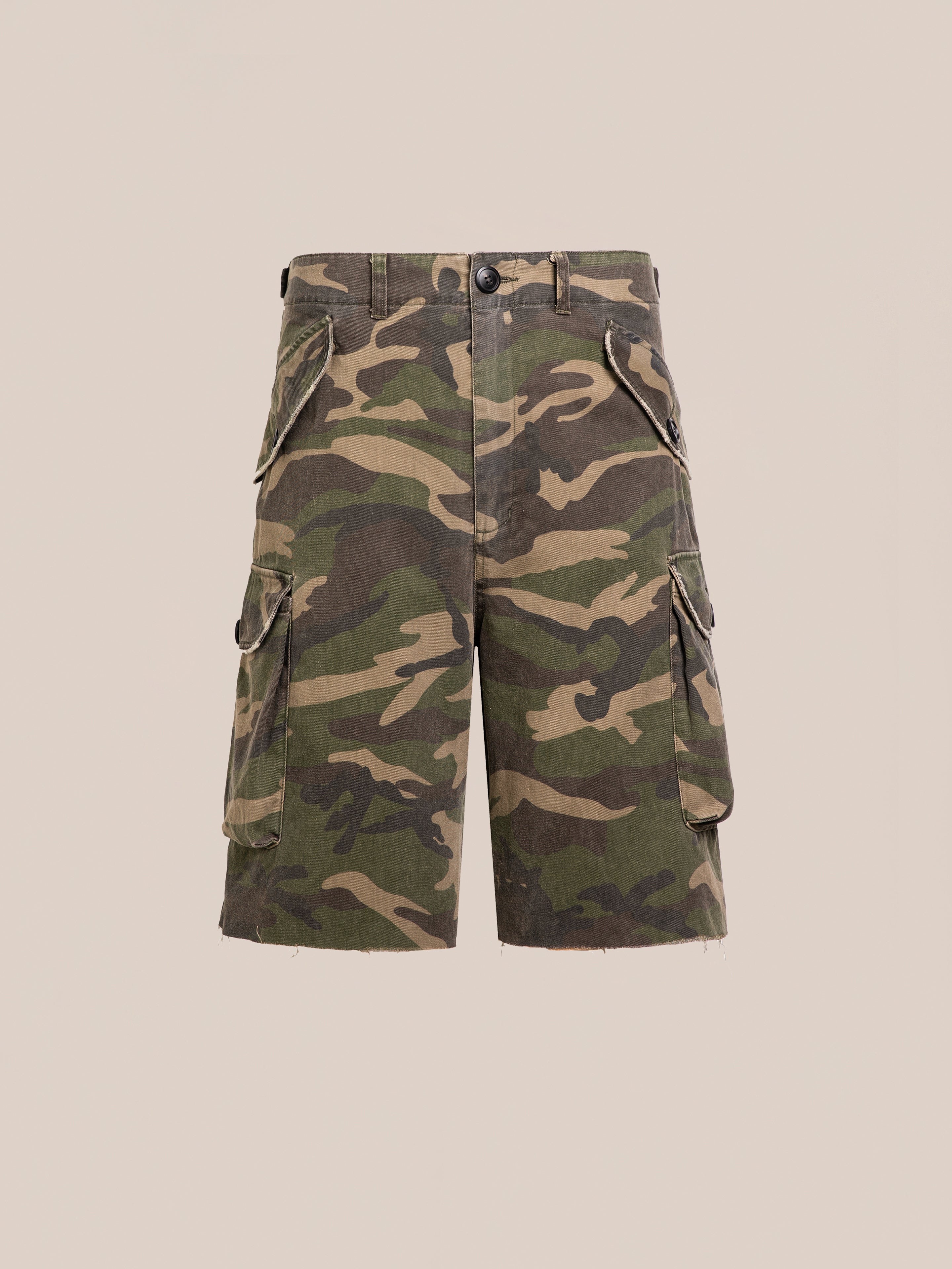 FOUND Camouflage Twill Utility Cargo Shorts feature a vintage green look, unisex relaxed fit, multiple pockets, button closure, and belt loops. Shown against a plain beige background.