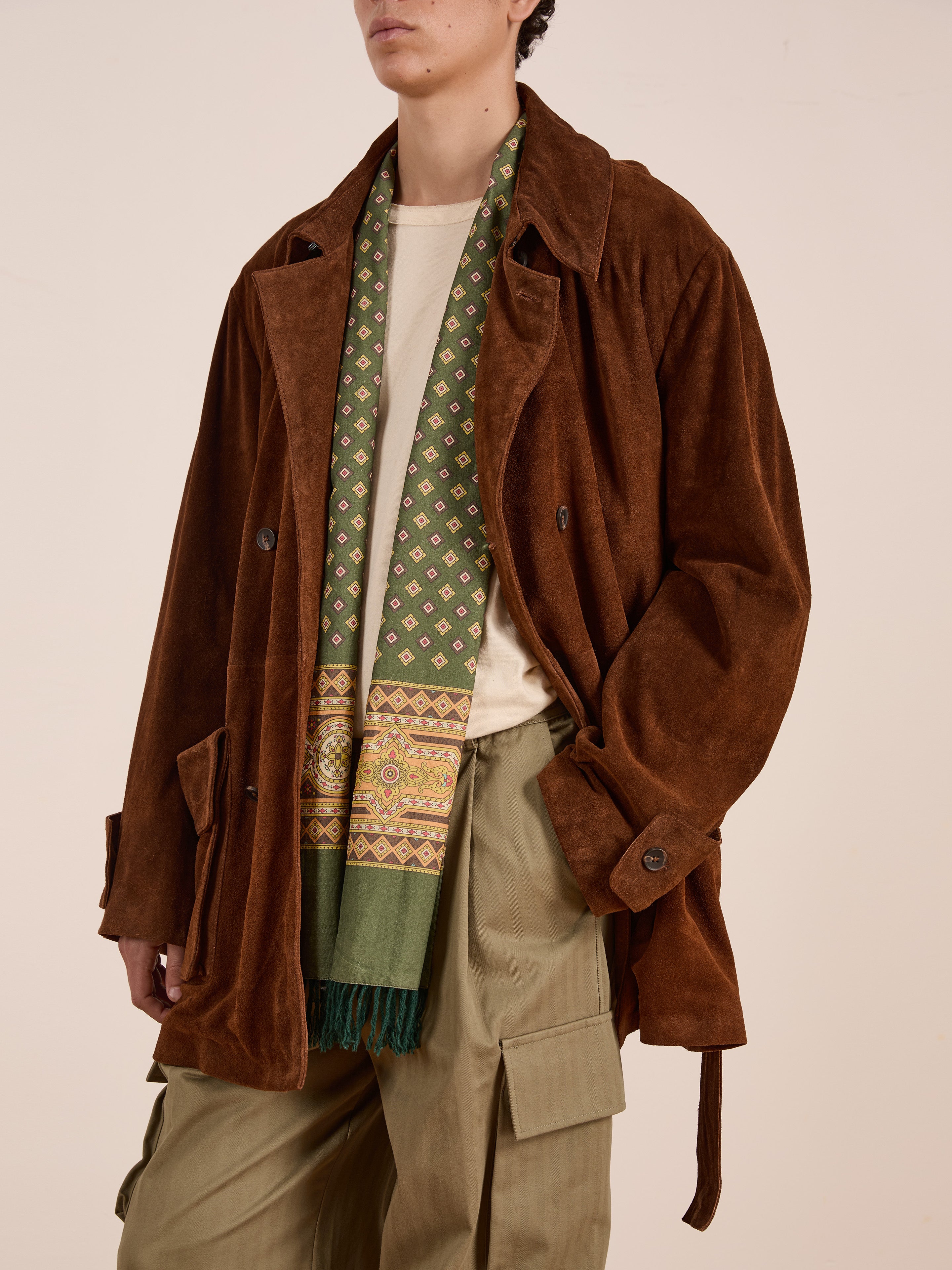 A person wears the FOUND Double Breasted Suede Leather Jacket over a beige shirt with a green patterned scarf and olive cargo pants, standing against a plain background.