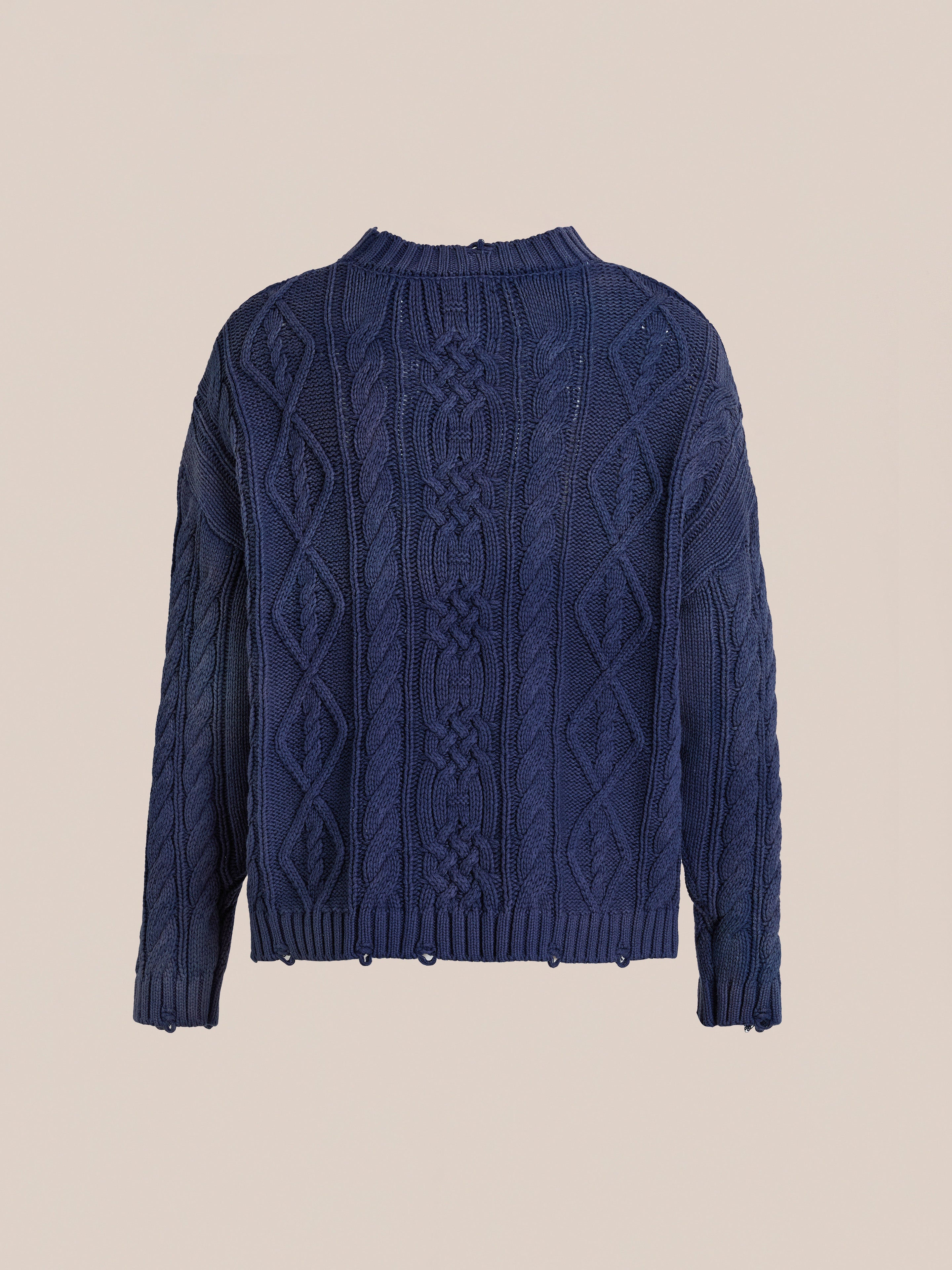 The Found Cable Knit Pullover Sweater is a navy blue unisex style with diamond and braided patterns, long sleeves, and ribbed hem and neckline, shown against a plain beige background.