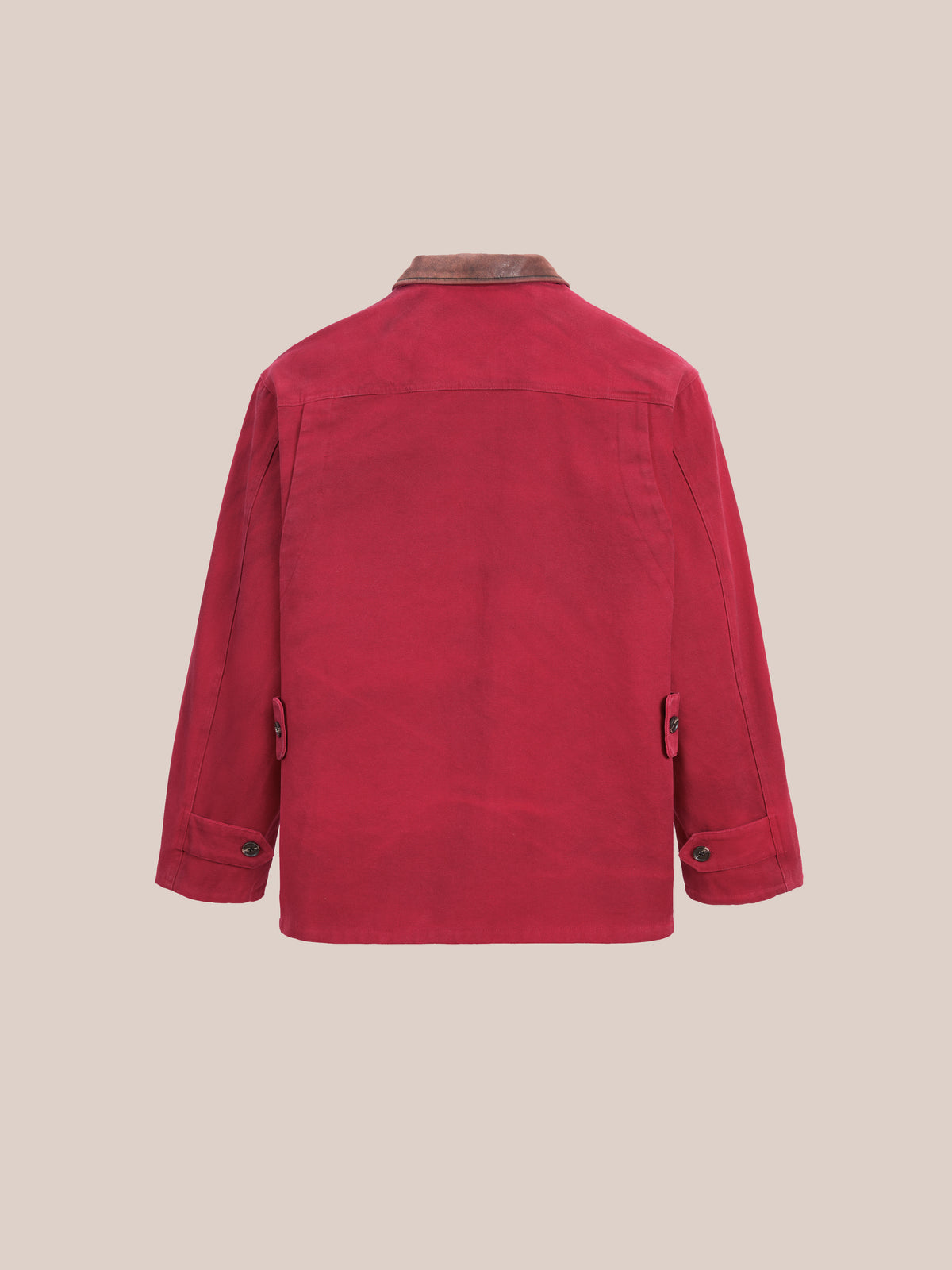 The Found Canvas Utility Barn Jacket in red, featuring a brown corduroy collar, is displayed from the back against a plain light background.