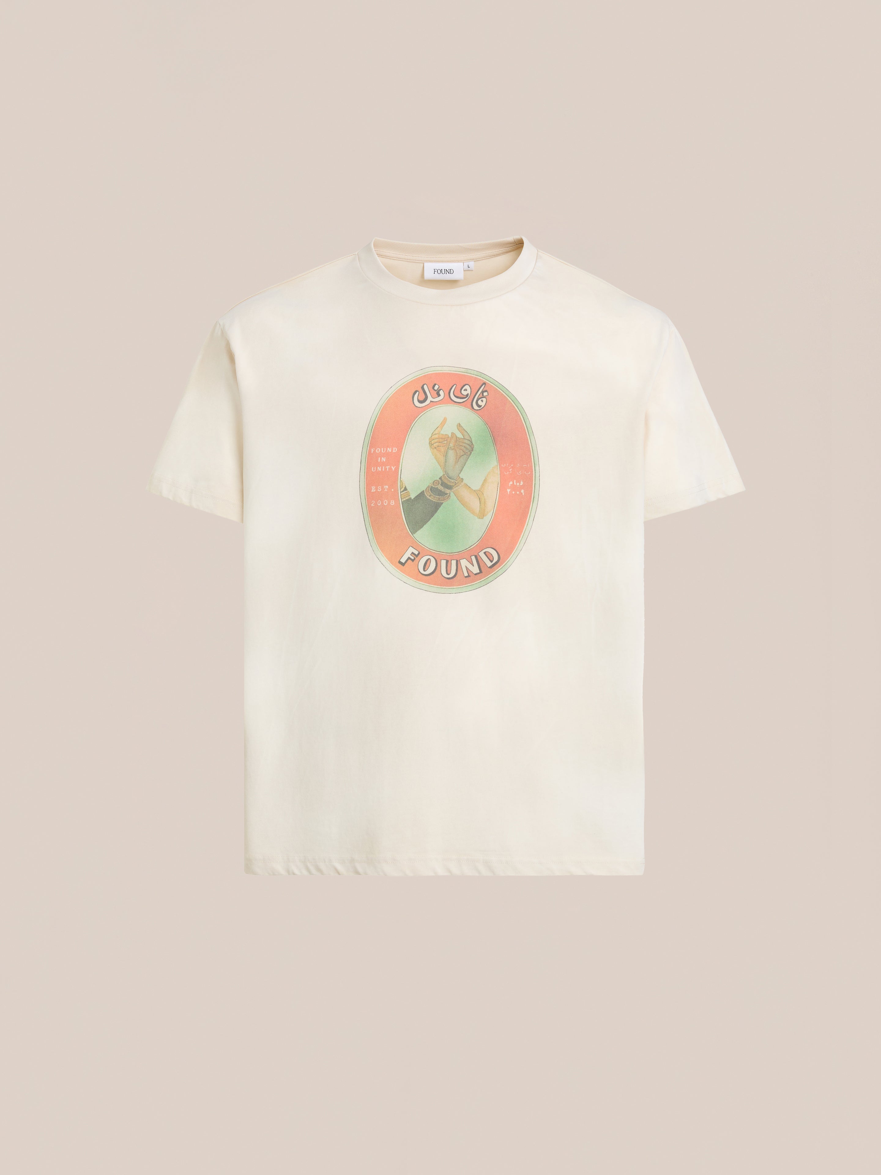 The FOUND Community Hands Tee is a cream unisex cotton shirt with a vintage matchbox-inspired graphic of a woman in a circle and "FOUND IN UNITY" printed below.