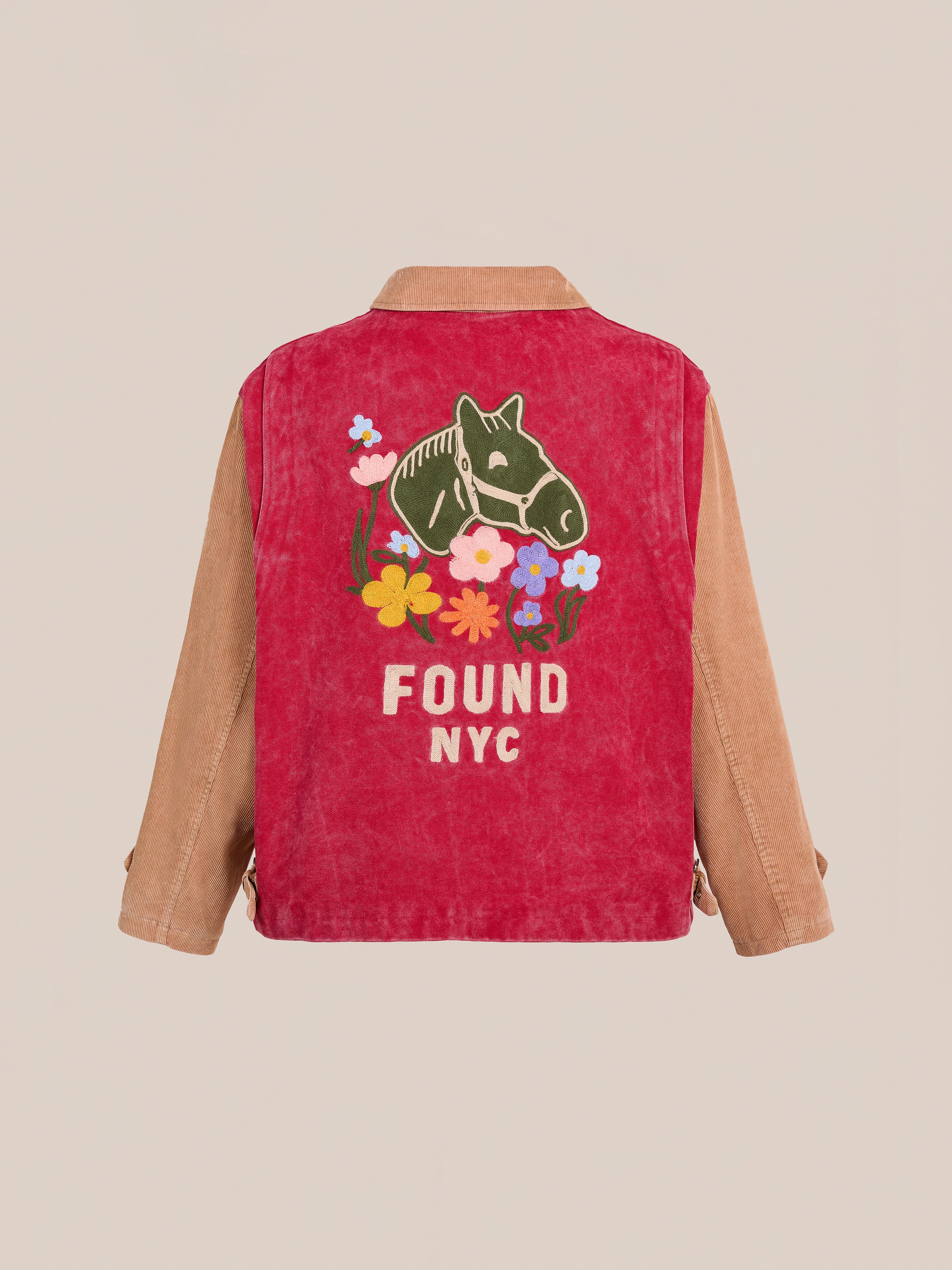 The Found Corduroy Field Jacket is a unisex workwear piece featuring tan sleeves, a red back, horse graphic, colorful flowers, and "FOUND NYC" embroidery—offering unique style and standout details.