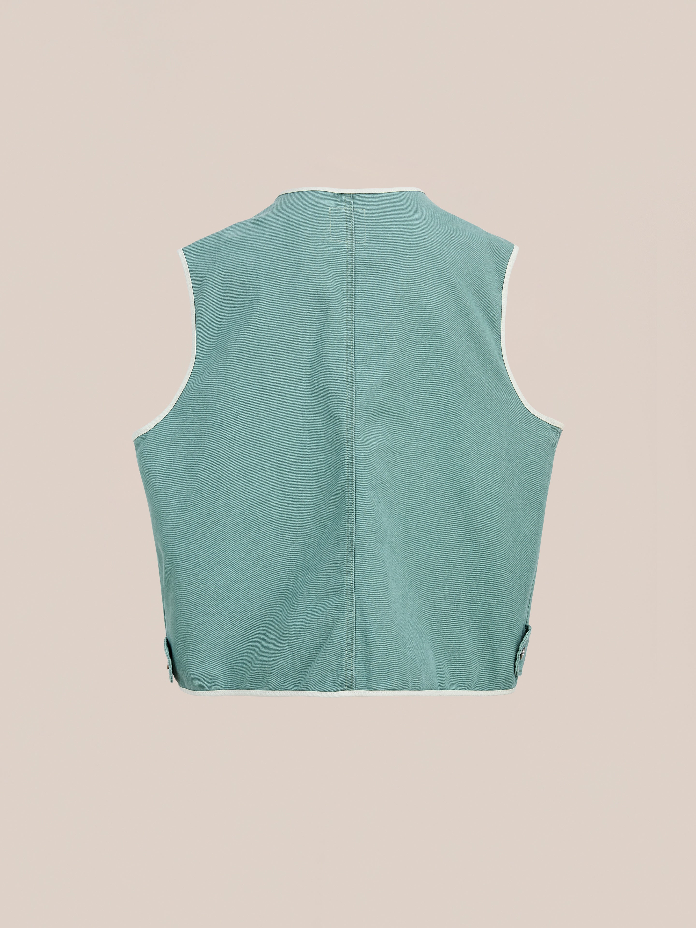 FOUND Cotton Twill Utility Vest in teal, sleeveless and shown from the back against a plain beige background.