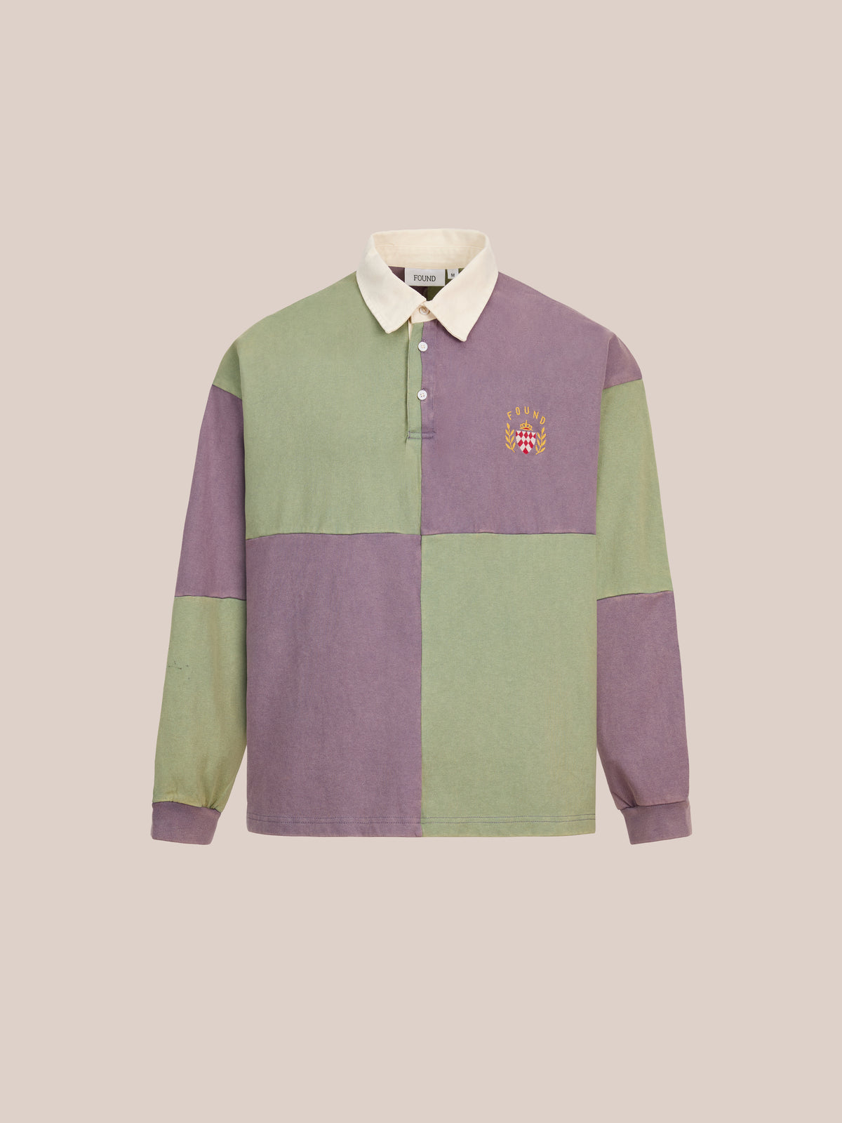 FOUND’s Crestfield Rugby is a unisex, relaxed-fit long-sleeve rugby shirt featuring bold purple and green color blocking, a beige collar, and an embroidered crest on the chest. Displayed on a plain background, this piece channels classic athletic style—making it a standout staple for vintage sportswear enthusiasts.