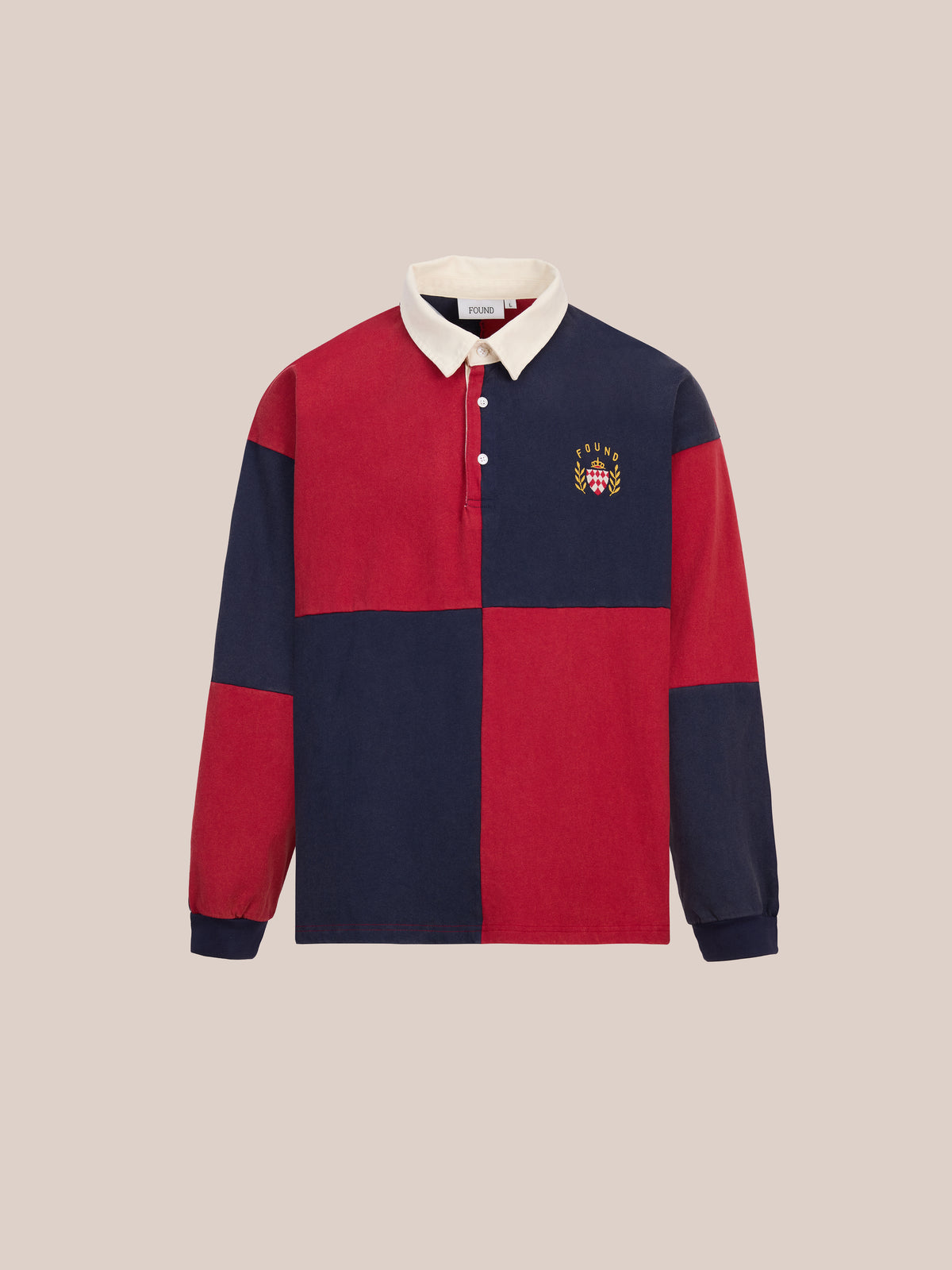 The FOUND Crestfield Rugby is a long-sleeve unisex shirt with a bold color block design featuring large red and navy sections, a white collar, buttoned placket, and a small embroidered crest on the left chest, displayed against a plain light background.