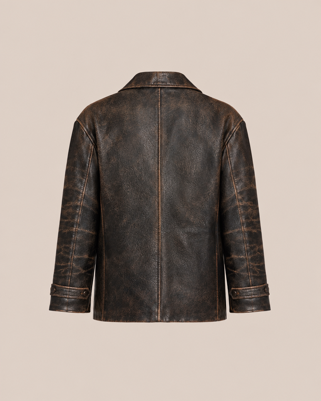 Back view of the FOUND Distressed Leather Blazer in genuine leather with straight hem, visible seams, and adjustable cuff straps on a beige background.