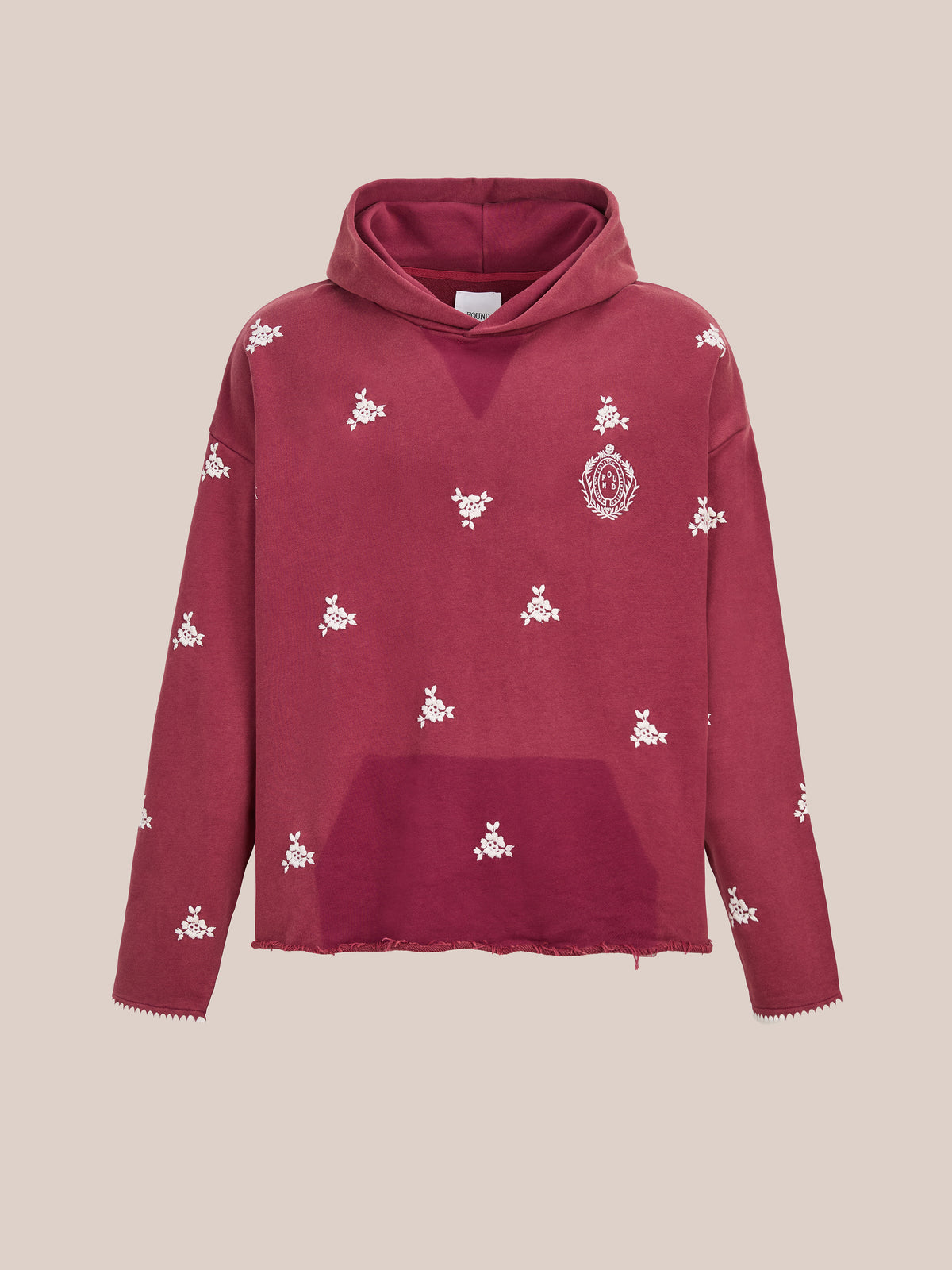 The FOUND Embroidered Motif Hoodie is a maroon unisex relaxed fit with white floral embroidery, chest patch, and raw-cut hem and cuffs on a plain background.