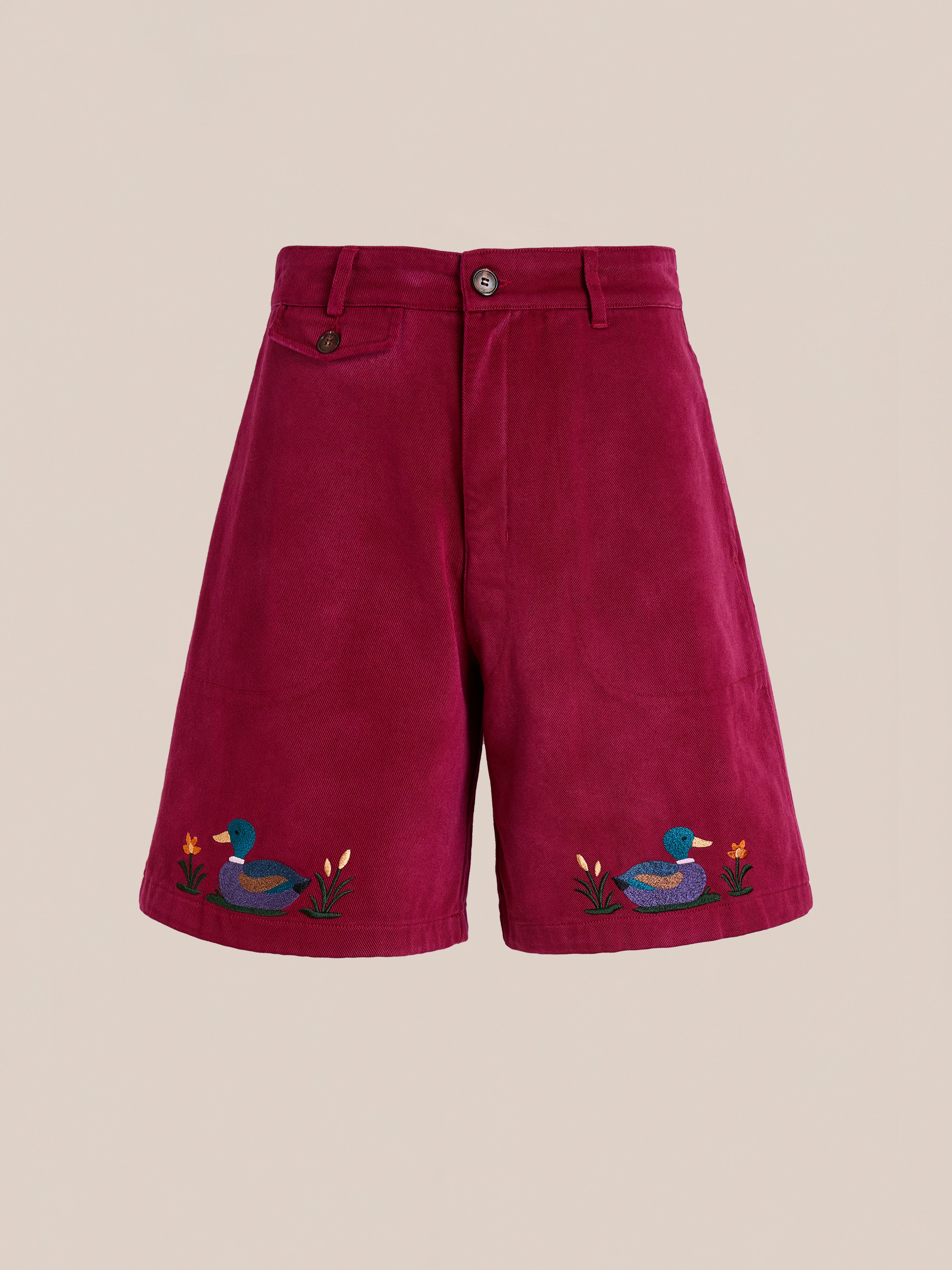 The Found Embroidered Duck Shorts feature a vintage maroon cotton canvas design with front button and zip closure, accented by embroidered ducks and flowers near the hem for a playful touch.