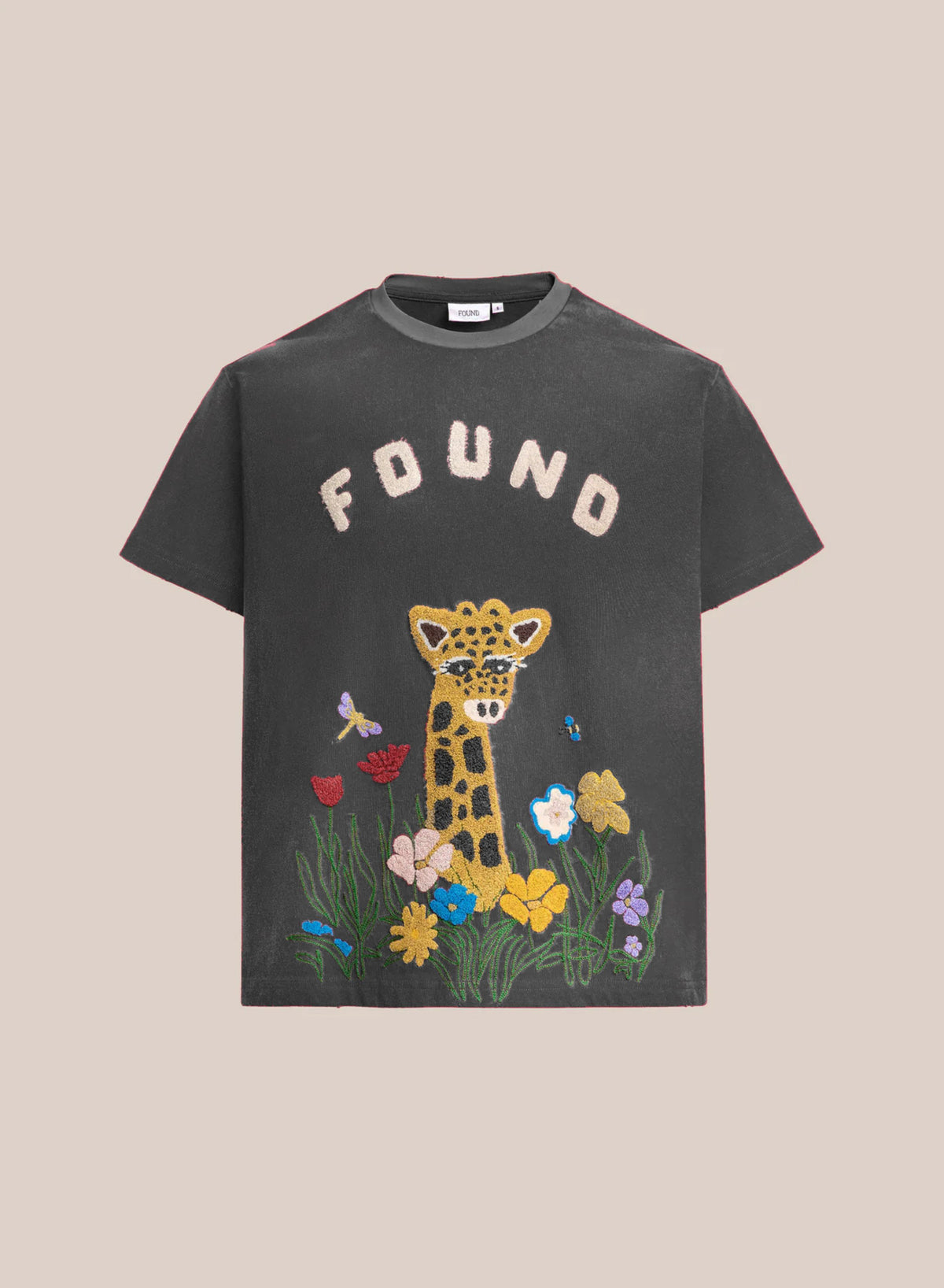 FOUND Embroidered Wildlife Tee: Black T-shirt with “FOUND” text above a chenille giraffe, colorful flowers, and butterflies on the front.