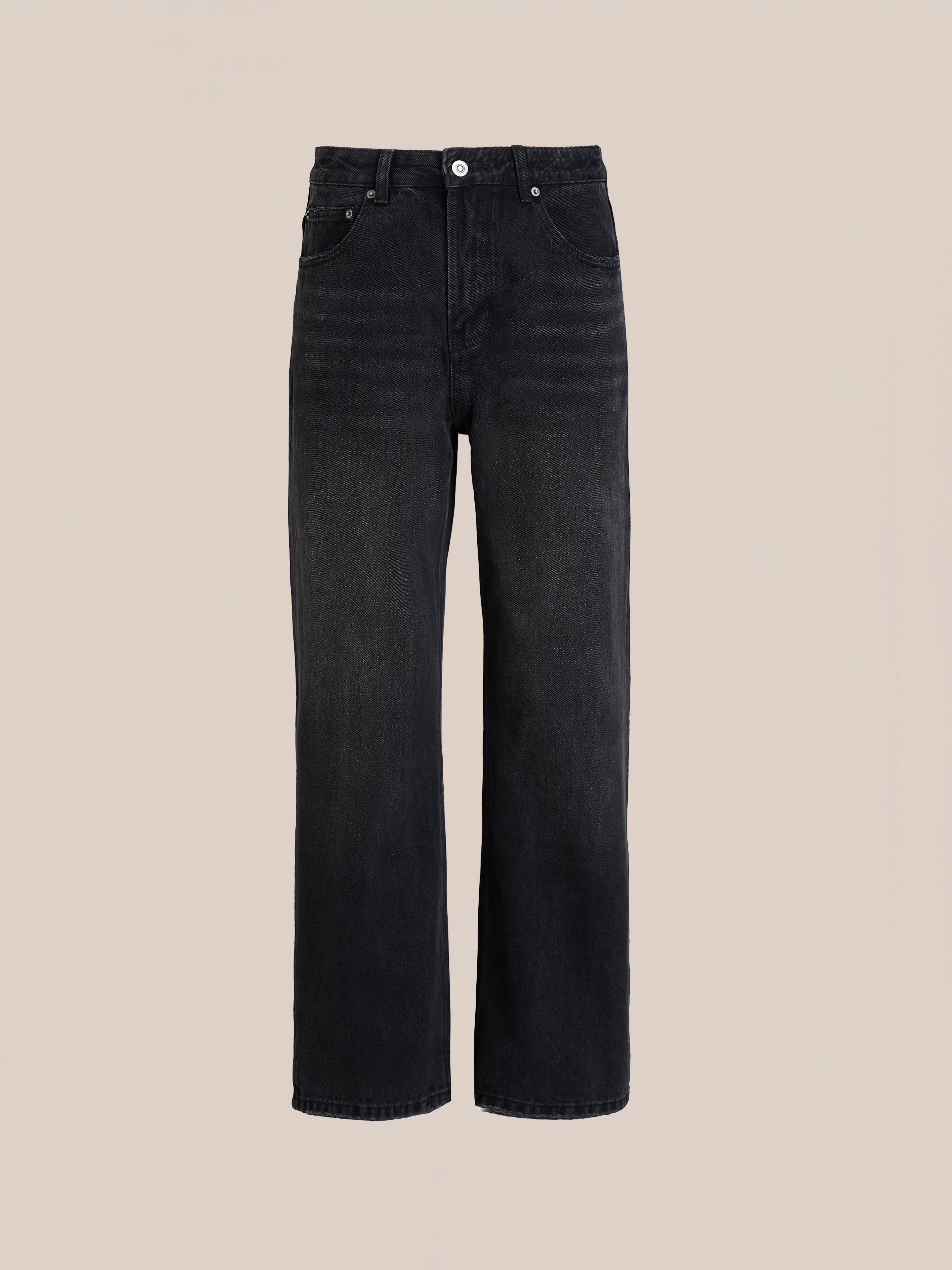 A pair of Flare Jeans by Found, featuring a vintage black wash, high-rise waist, straight-leg fit, five pockets, and button closure, displayed on a plain beige background.