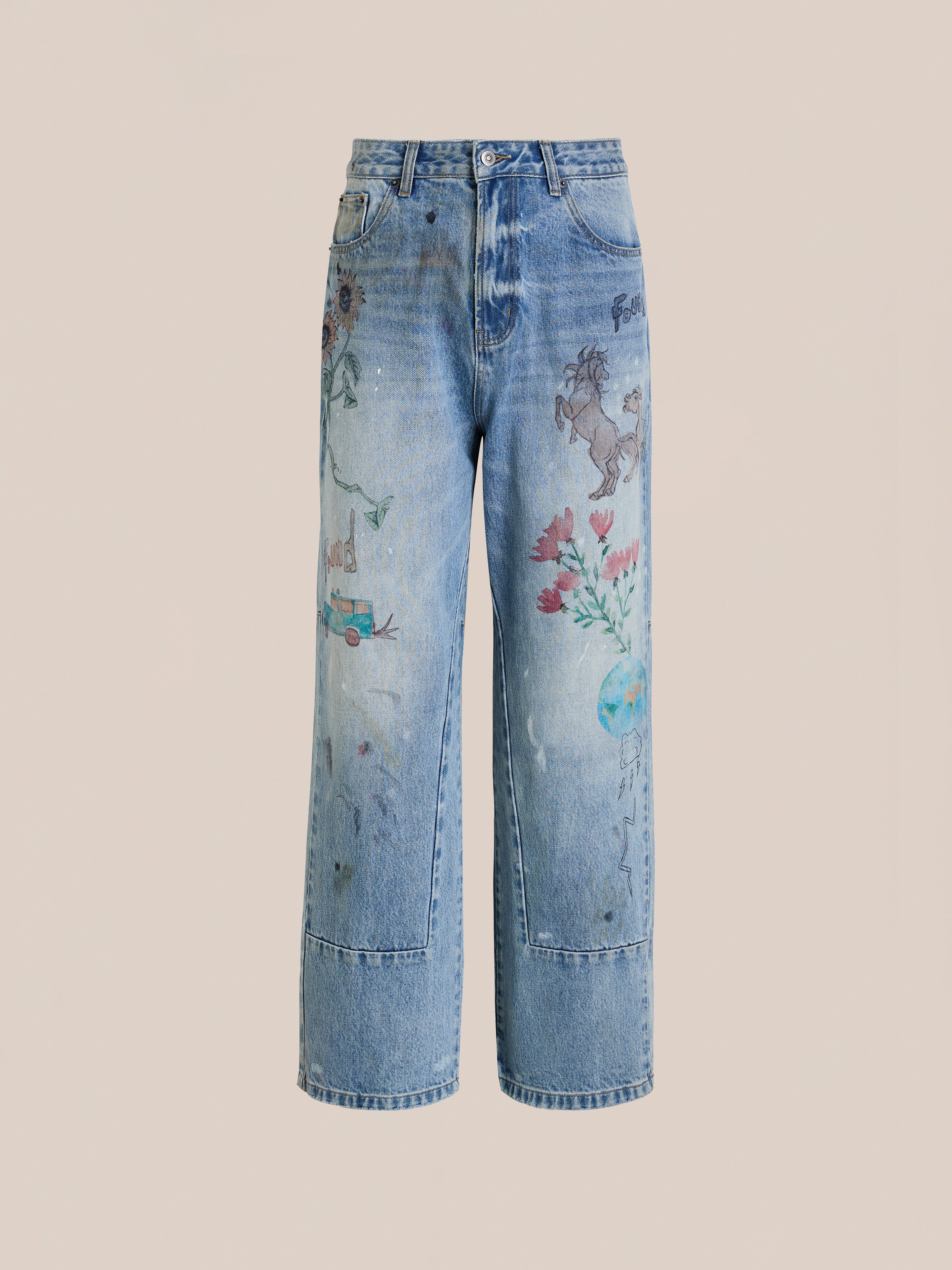 Hand Art Jeans by FOUND: light blue, wide-leg denim with faded details and colorful hand-drawn graphics—flowers, car, animals, and a globe—featured on a plain beige background.