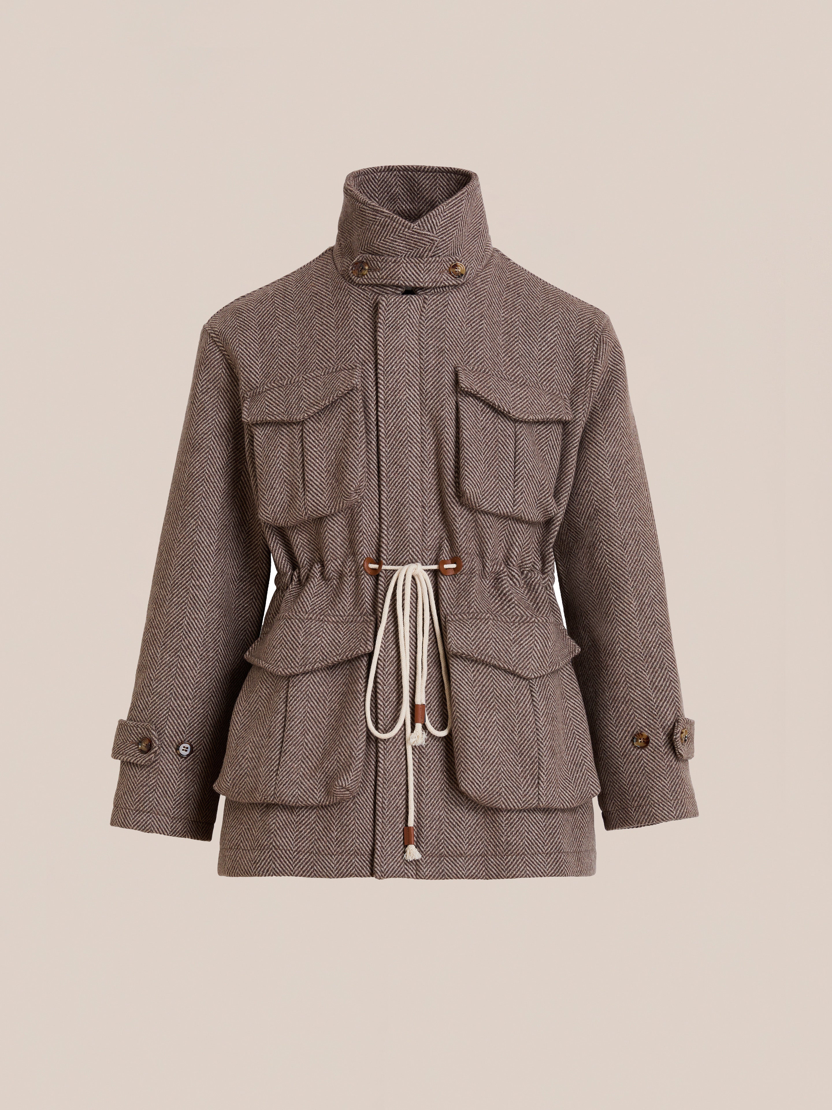 The FOUND Herringbone Wool Barn Jacket features a brown herringbone wool blend, high collar, four front pockets, buttoned cuffs, and a white waist drawstring, shown against a neutral background.