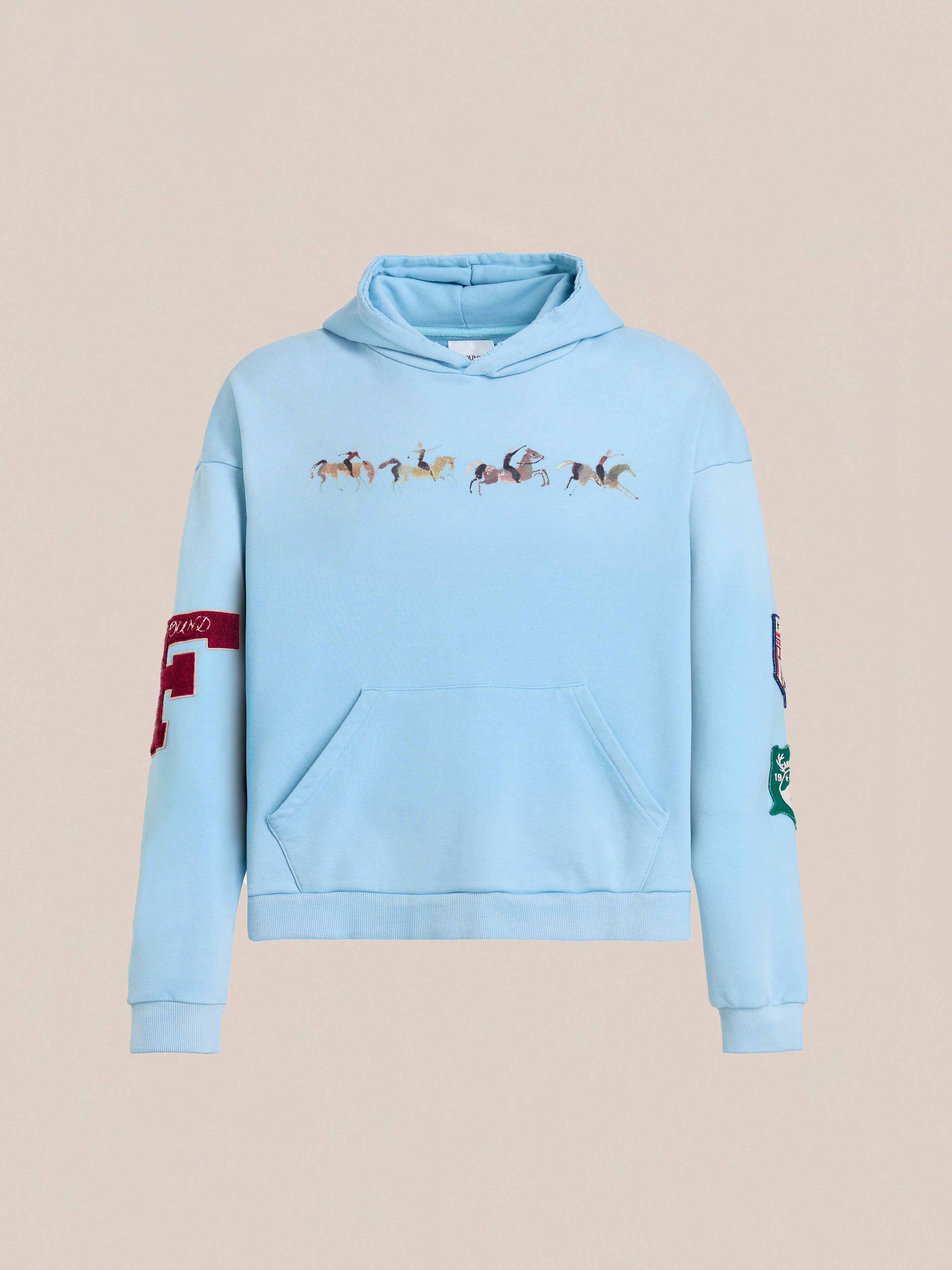 The FOUND Horse Line Hoodie is light blue French Terry cotton with an equestrian chest graphic, front pocket, red number 4 patch on the right sleeve, and green patch on the left for a vintage look.