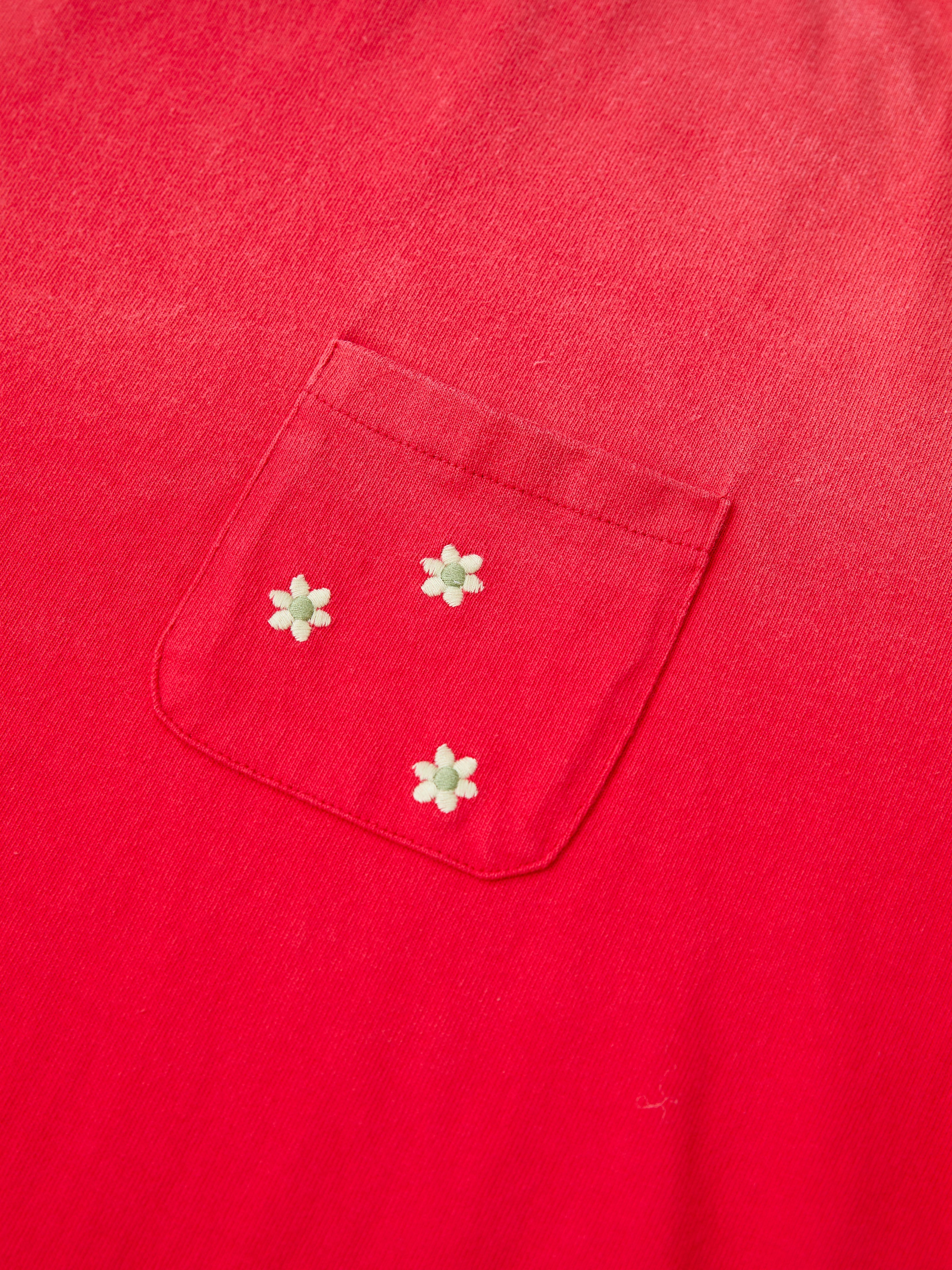 The FOUND Horse Motif Embroidered Tee is a unisex relaxed fit red vintage wash t-shirt with a chest pocket accented by three small white horse motif embroideries, blending comfort with distinctive charm.