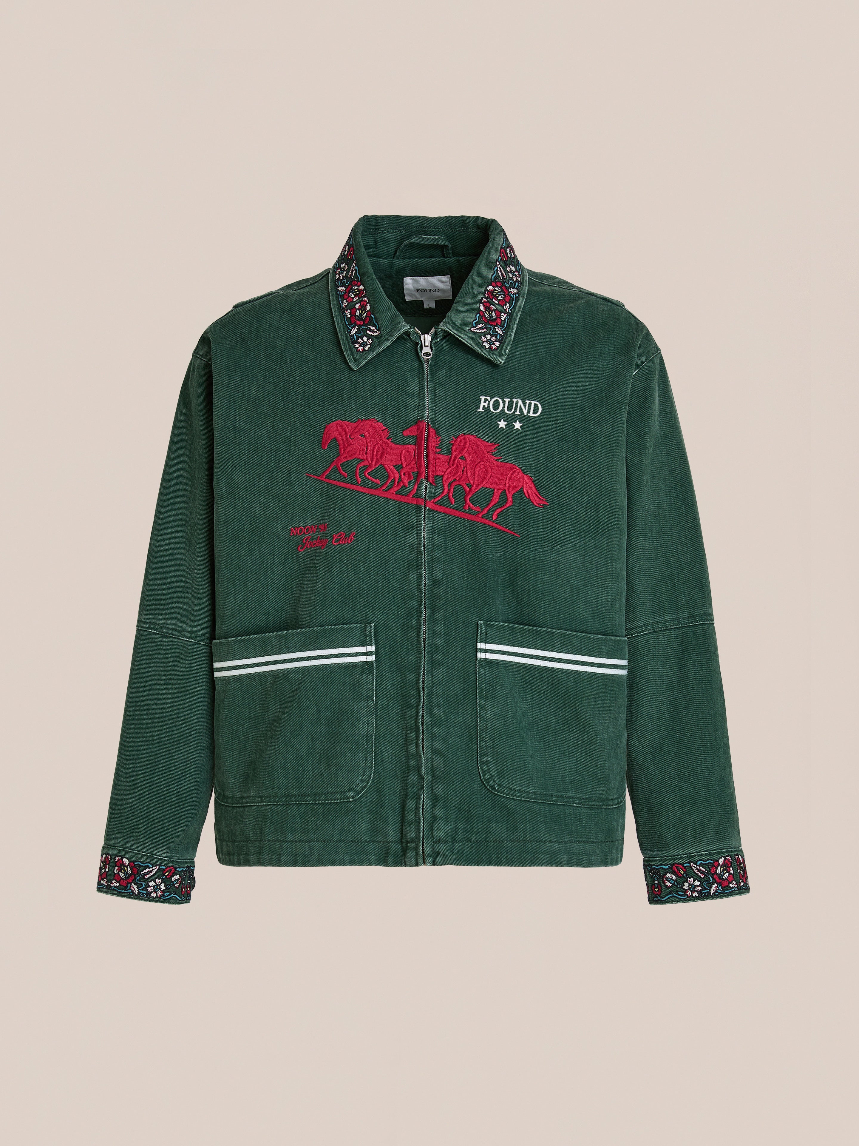 The Found Jockey Club Embroidered Jacket features racing horse embroidery, a front zipper, “FOUND” text, patterned cuffs and collar, two white-accented front pockets, and a relaxed unisex fit.
