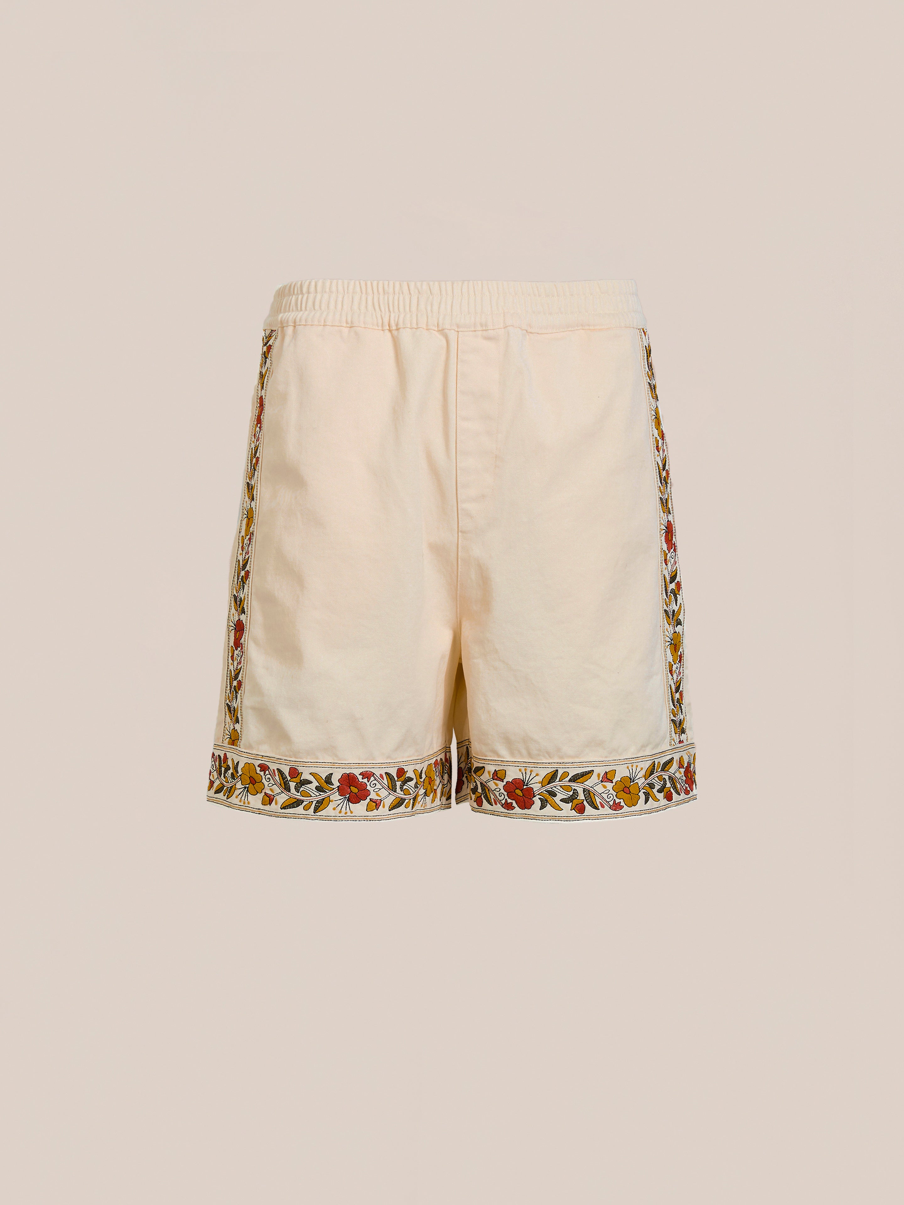Explore the FOUND Kantha Floral Work Shorts, made from 100% cotton. These beige shorts showcase vivid floral embroidery along the sides and hem for a chic touch against a minimalist backdrop.