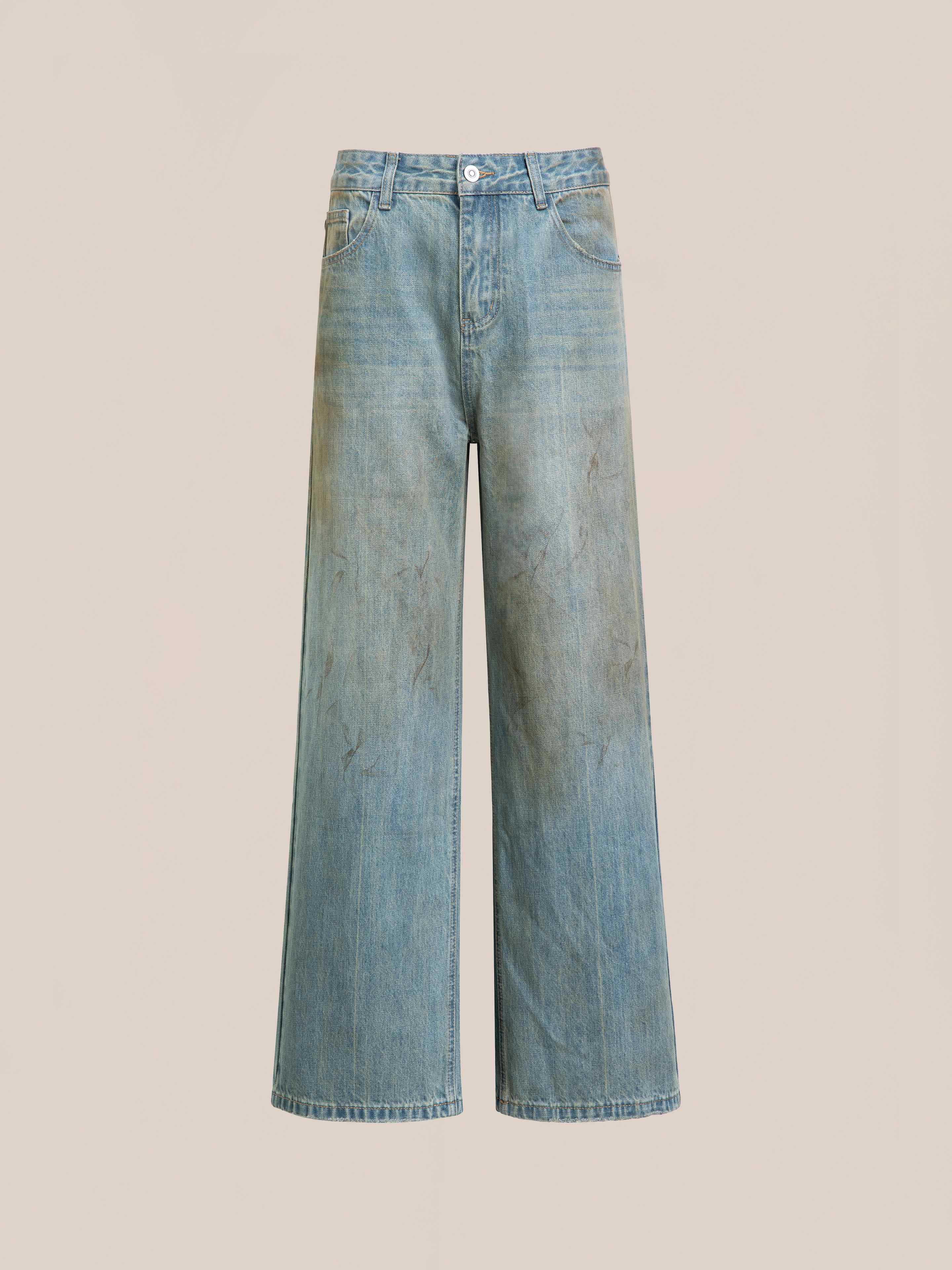 FOUND’s Lacy Baggy Jeans feature a unisex, relaxed fit with wide legs, a high waist, and subtle faded patches on the front. Displayed against a plain background.