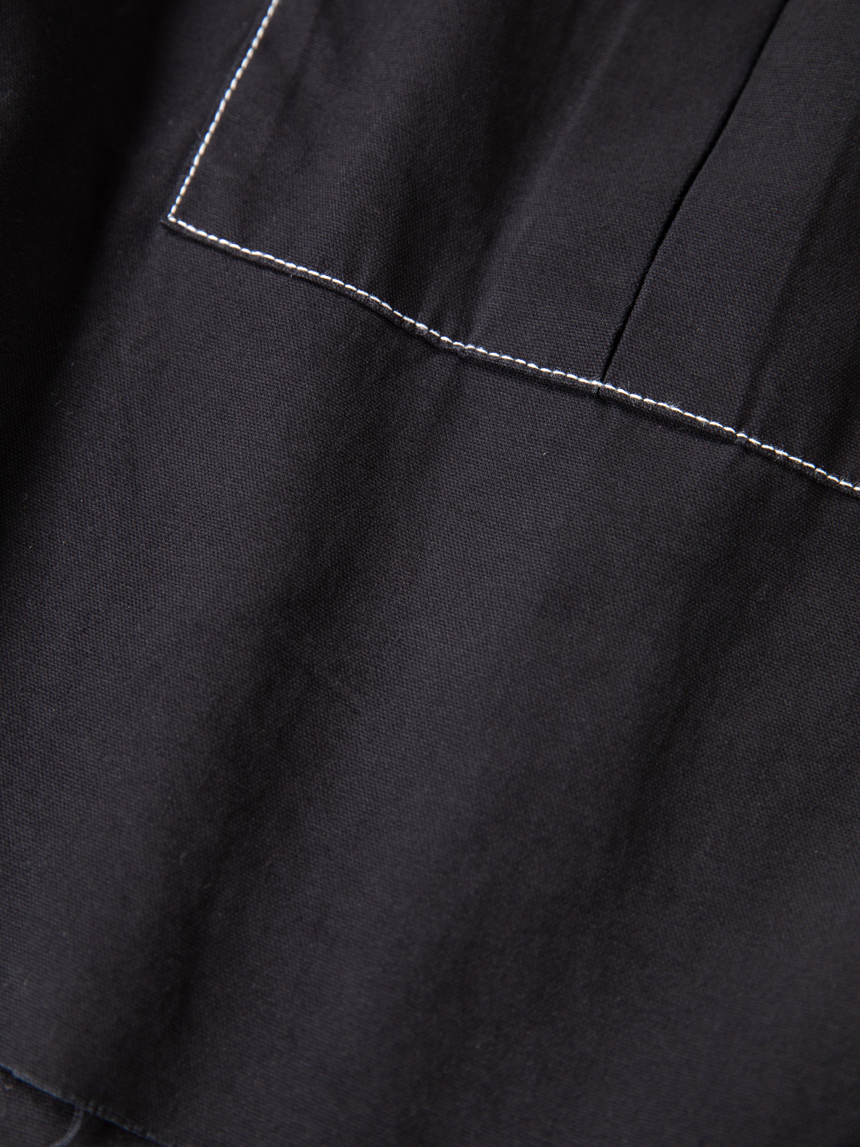 Close-up of FOUND Lucca Black Contrast Pocket Trouser Shorts, showcasing a relaxed fit, white seam stitching, and distinctive contrast pocket detail.