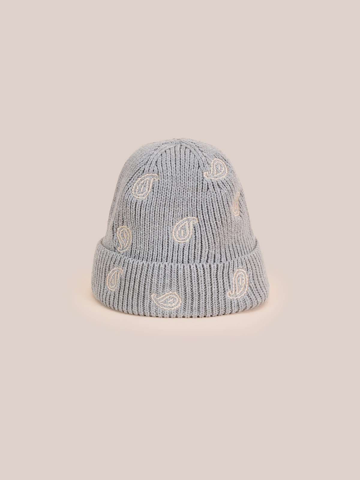 The FOUND Paisley Beanie in gray features a folded brim and white embroidered bandana print, shown against a plain beige background.