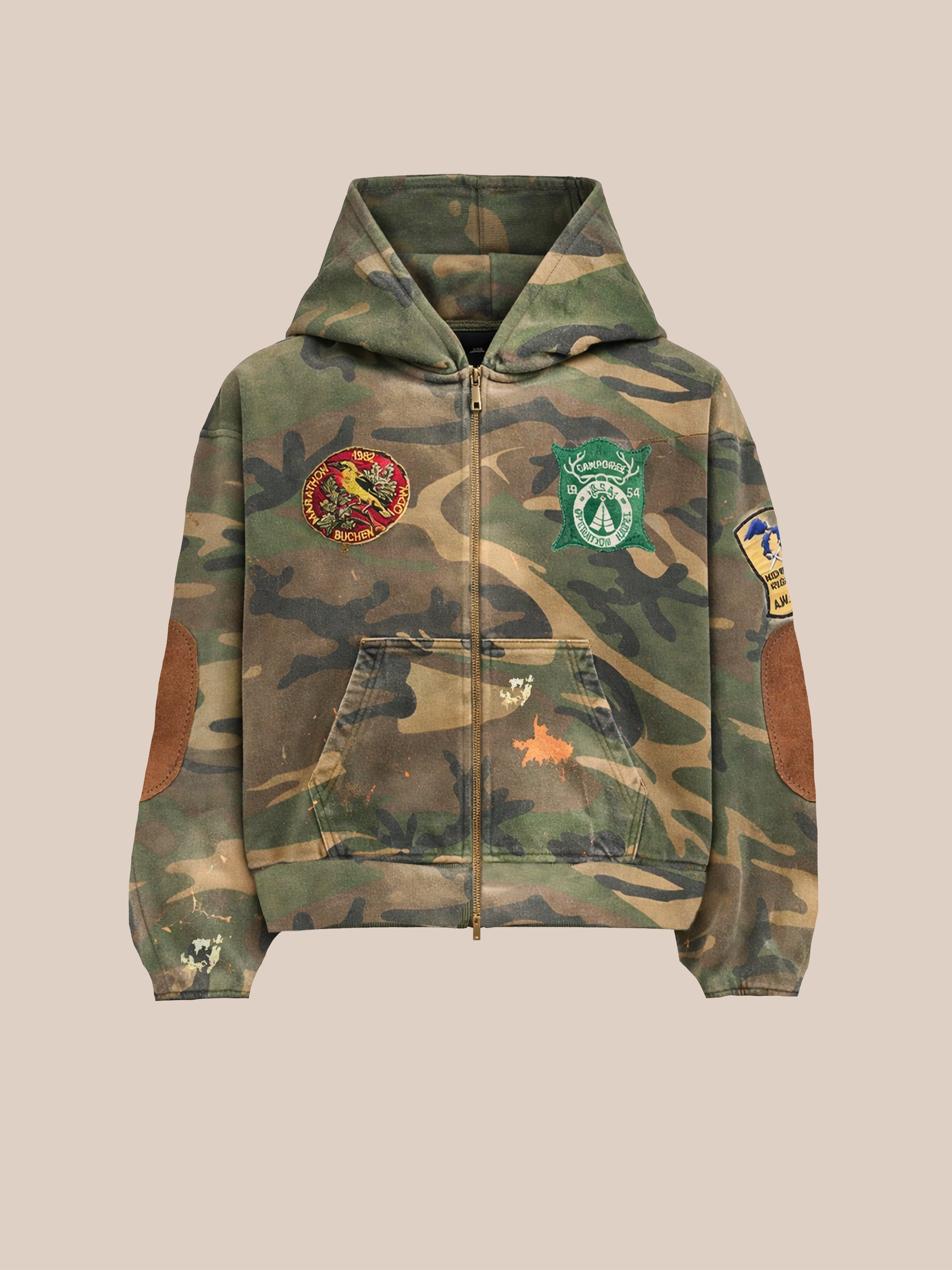 The FOUND Patch Camo Zip Up Hoodie offers a unisex relaxed fit with chest and sleeve patches, brown elbow details, and distressed camo fabric—perfect for rugged everyday wear.