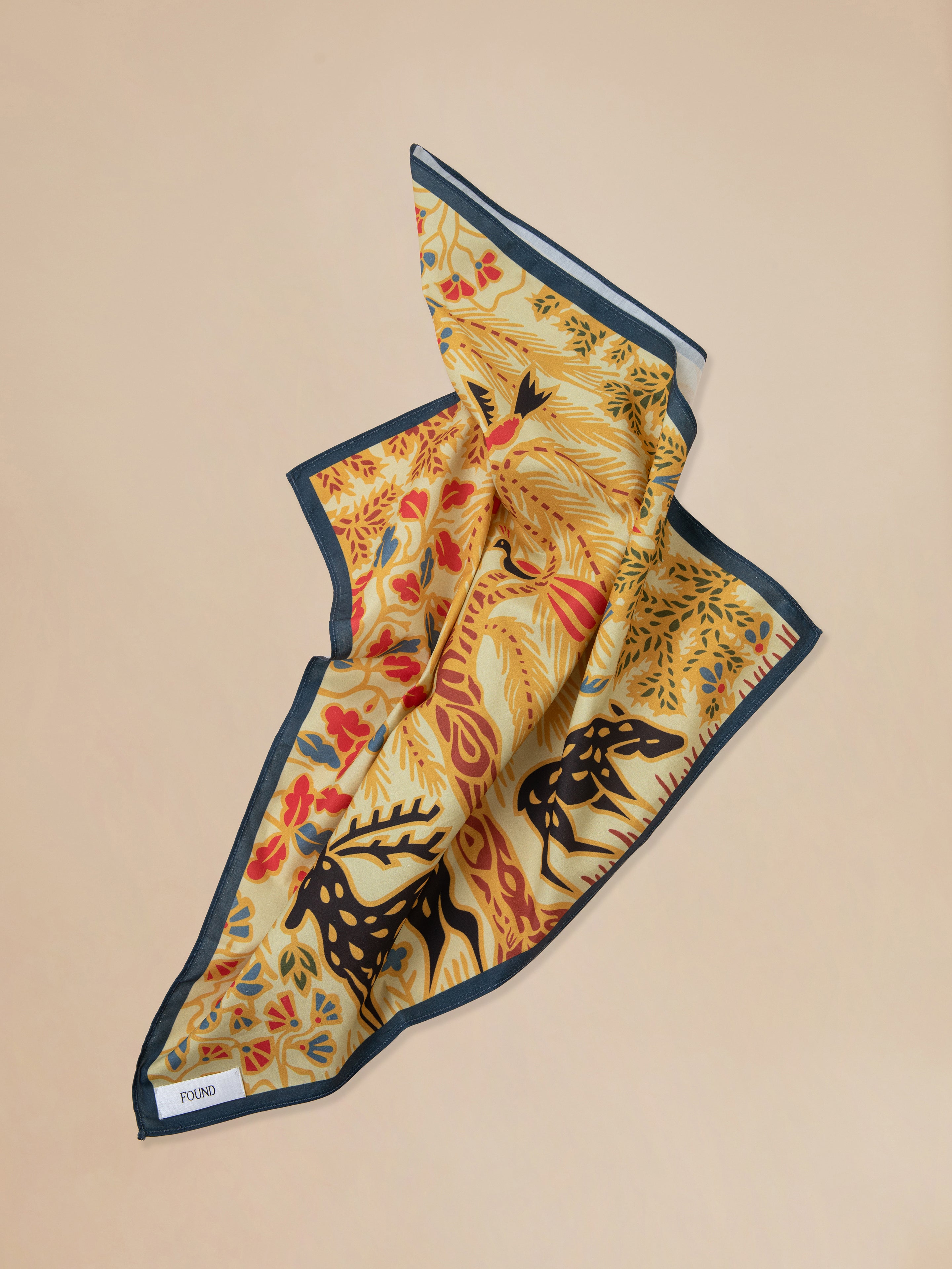 A pre-order image of a Found Rainforest Bandana featuring Phulkari artwork with a deer motif.