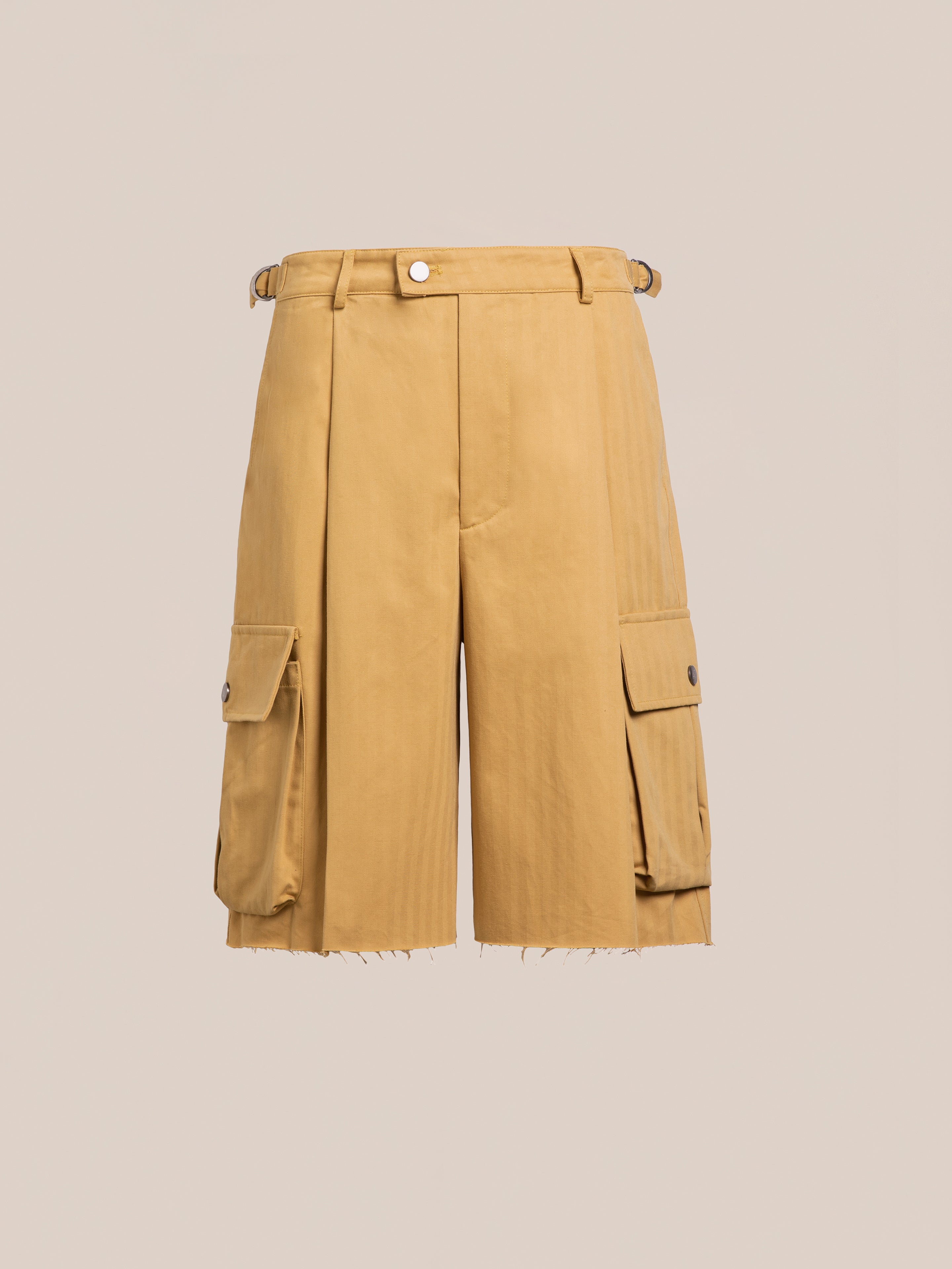 FOUND Sunlight Twill Cargo Shorts: unisex khaki herringbone twill with front pleats, side utility pockets with button flaps, belt loops, and a raw-edge hem, shown on a plain beige background.
