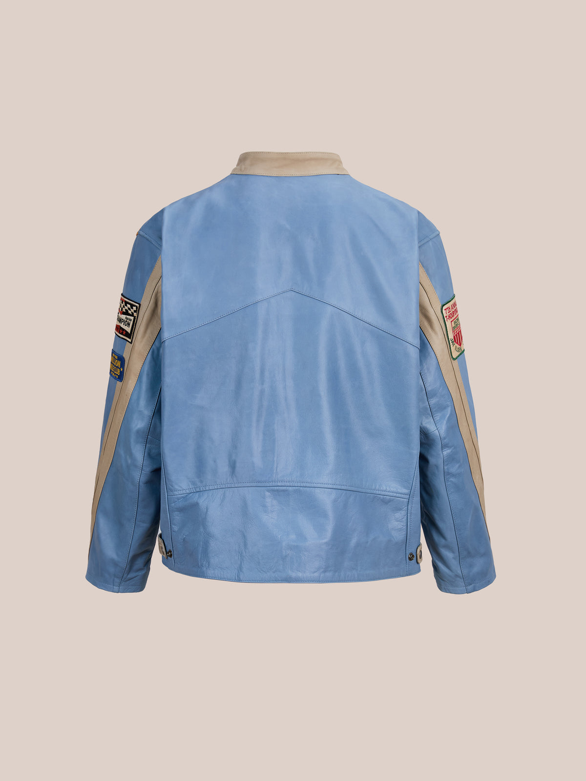 The FOUND Sport Racer Jacket in light blue and beige features racing-inspired sleeve patches, shown from the back against a plain light background.