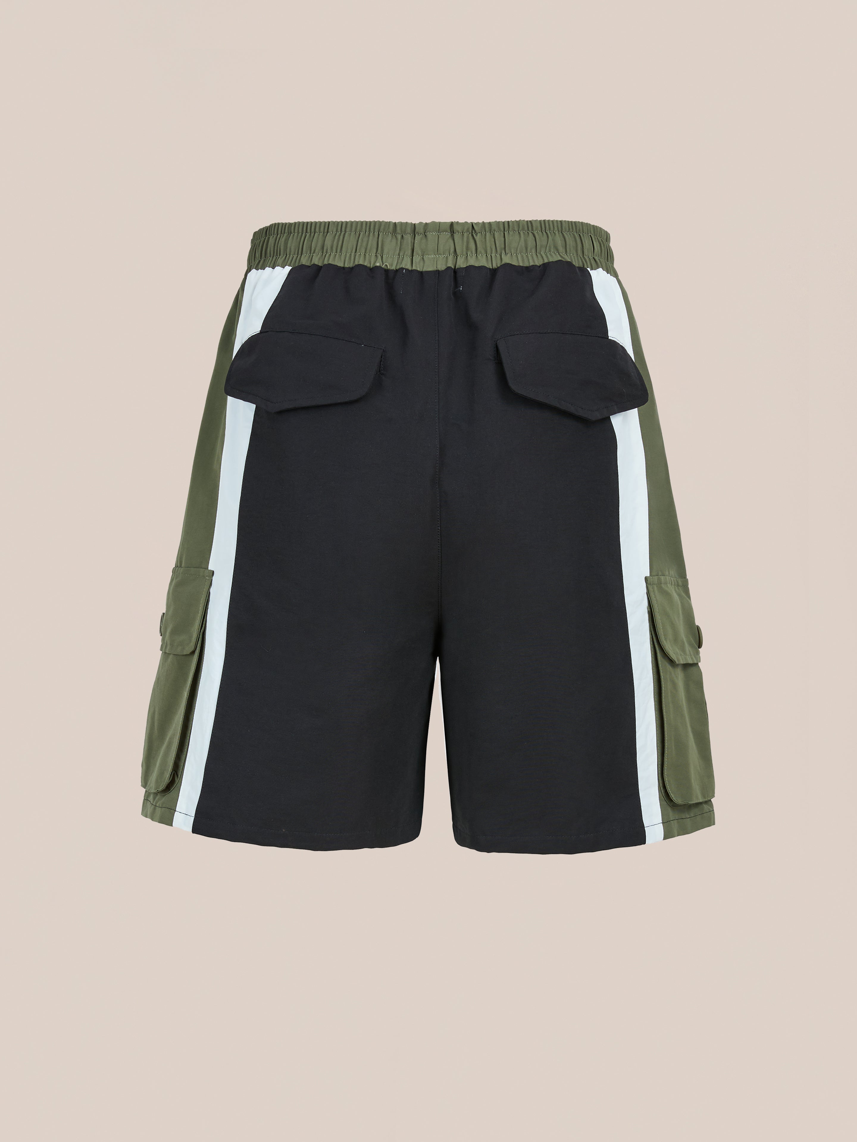 Back view of Found Sporting Club Track Shorts, unisex athletic shorts in black and olive green with white side stripes, elastic waistband, flap back pockets, and cargo pockets inspired by vintage styles.