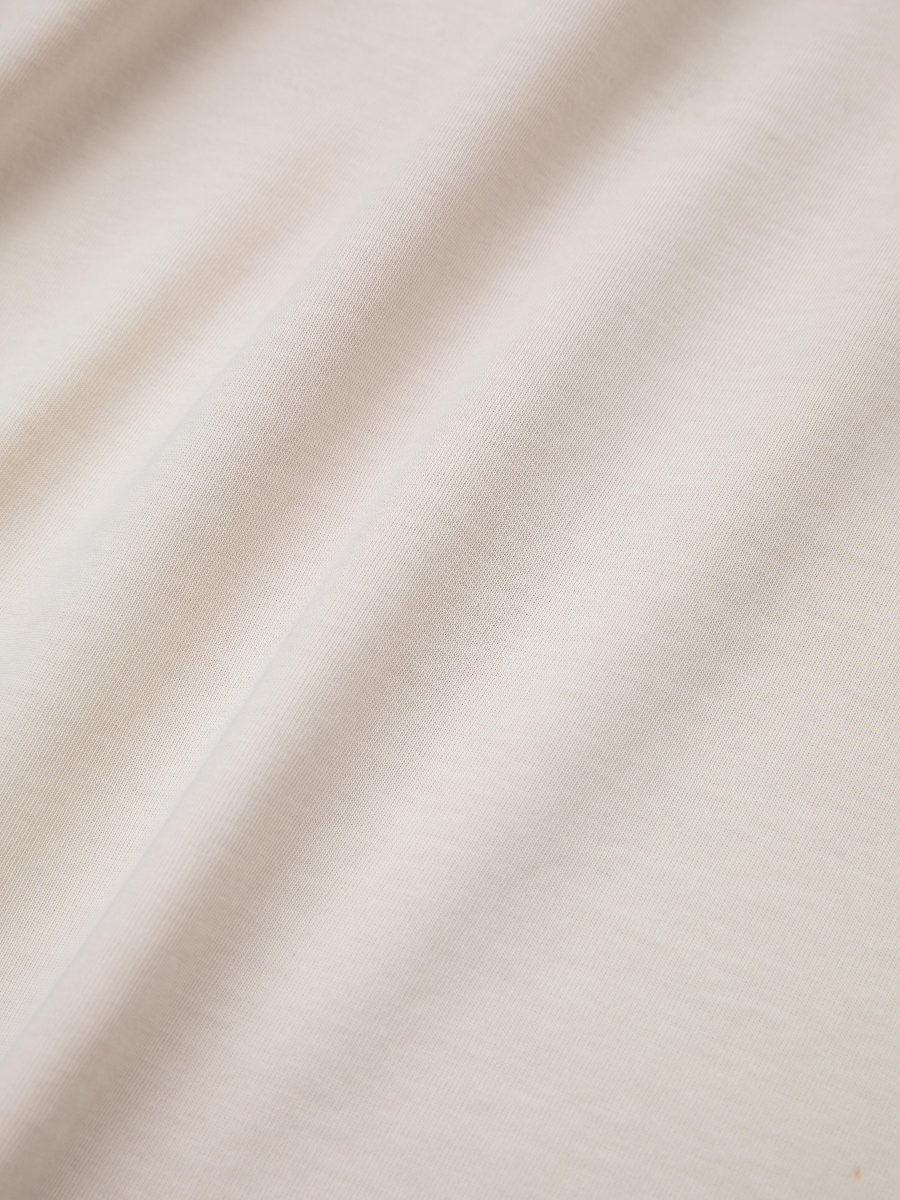 Close-up of the Union Soccer Jersey by FOUND, featuring a white fabric with subtle diagonal folds and a smooth texture, reminiscent of a vintage football jersey.