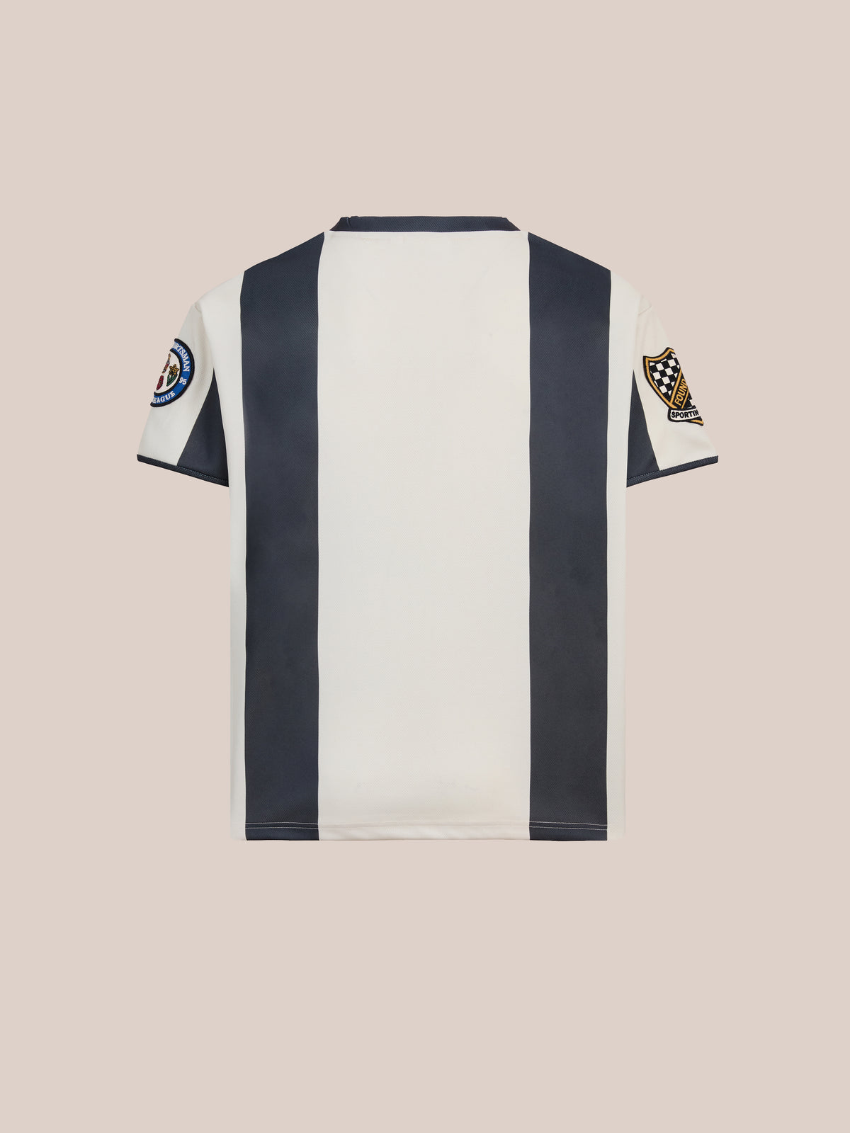 The Striped Stateman Jersey by FOUND features vertical black and white stripes with two sleeve patches, shown on a light beige background—ideal unisex sportswear.