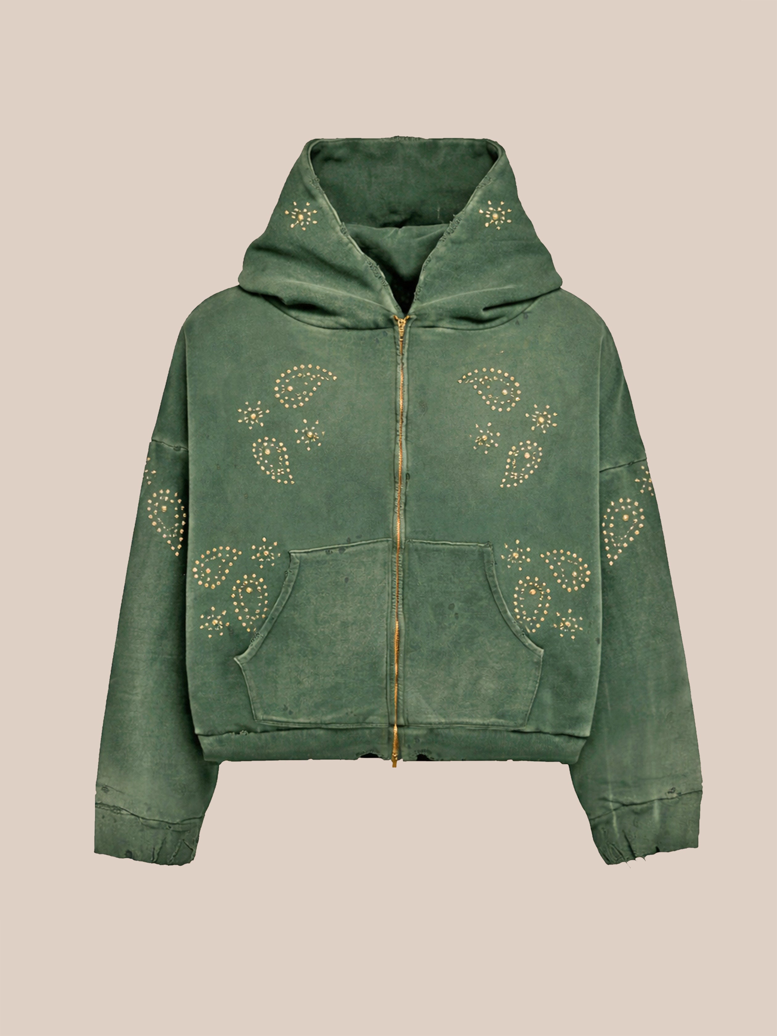 The FOUND Studded Zip Up is a green unisex hoodie with paisley patterns, gold studs on the front, sleeves, and hood, a front pocket, and relaxed fit. Shown on a plain beige background.