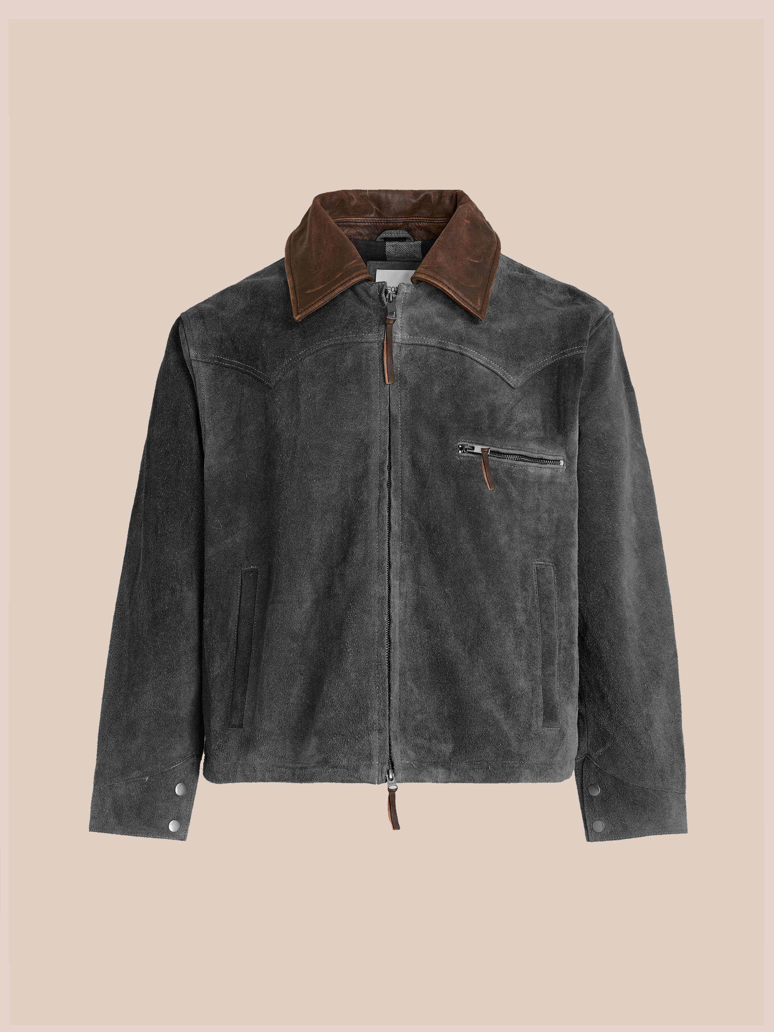 The FOUND Suede Western Work Jacket features dark grey suede with a vintage black finish, brown leather collar, front zipper, chest and side pockets, buttoned cuffs, and a unisex relaxed fit, shown on a neutral background.