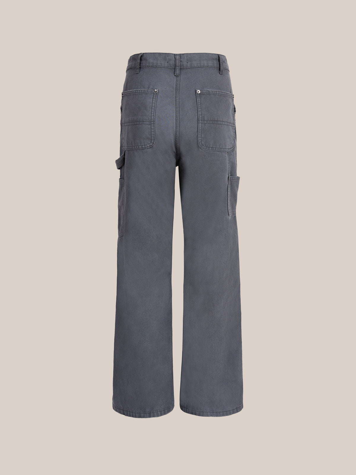 Sunbleached Utility Pants by FOUND shown from the back, with two back pockets, side pockets, and wide legs in a vintage workwear style on a plain beige background.