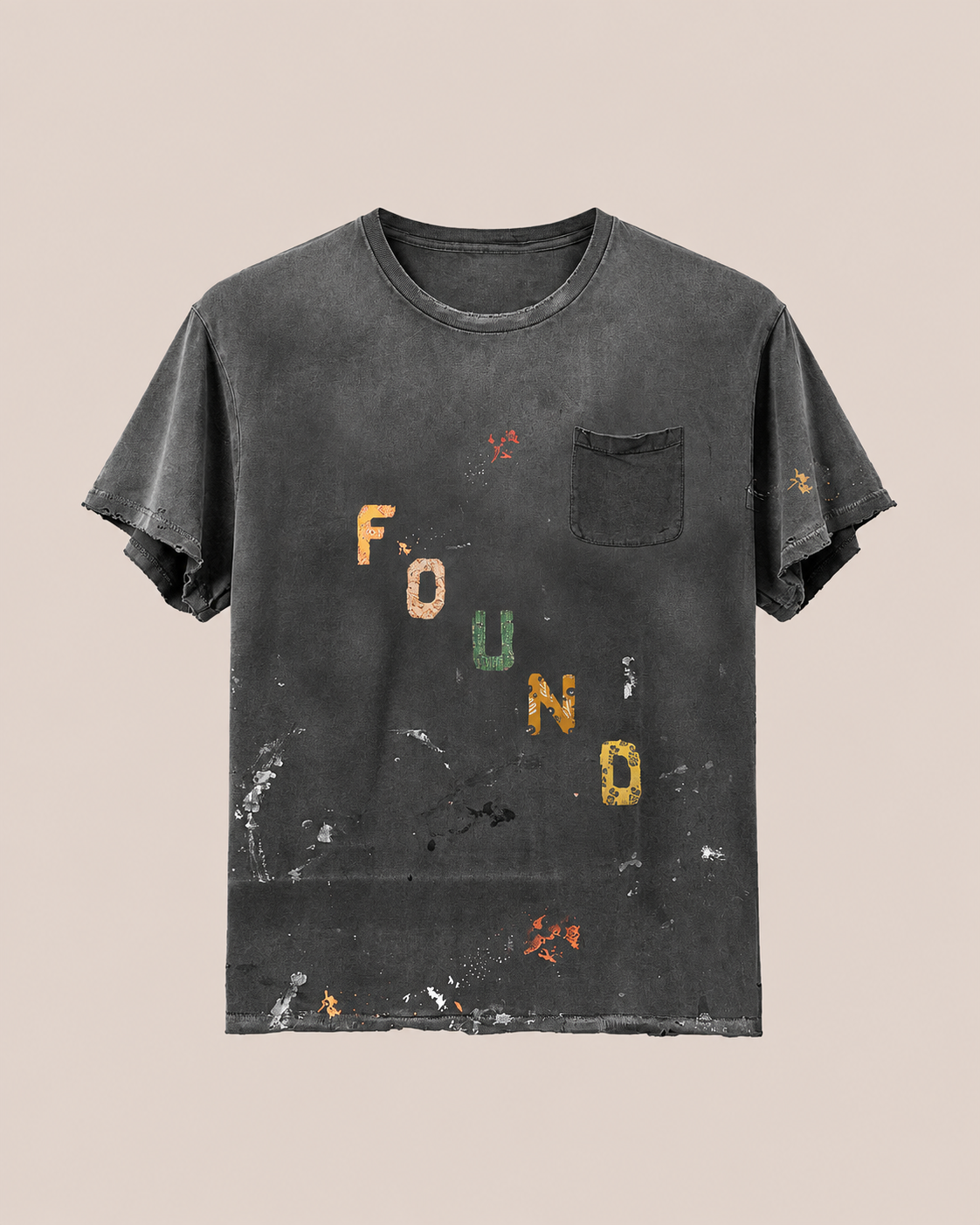 The Tapestry Logo Paint Tee by FOUND features a faded black paint splatter design, front pocket, colorful “FOUND” lettering, and a unisex relaxed fit.