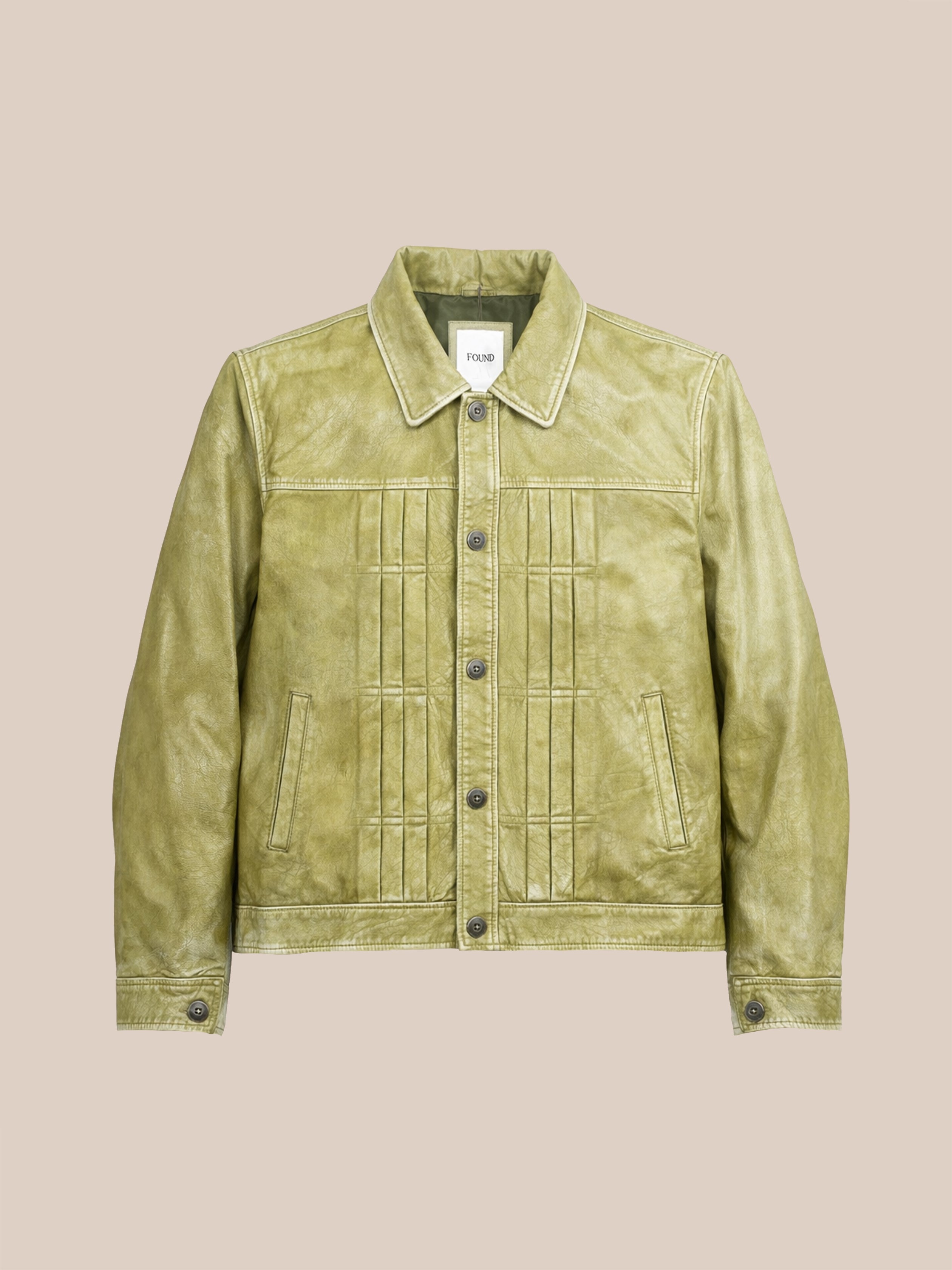 The FOUND Trucker Leather Jacket in light washed green features a collar, button front, vertical stitching details, and two side pockets in a relaxed fit, shown on a plain beige background.