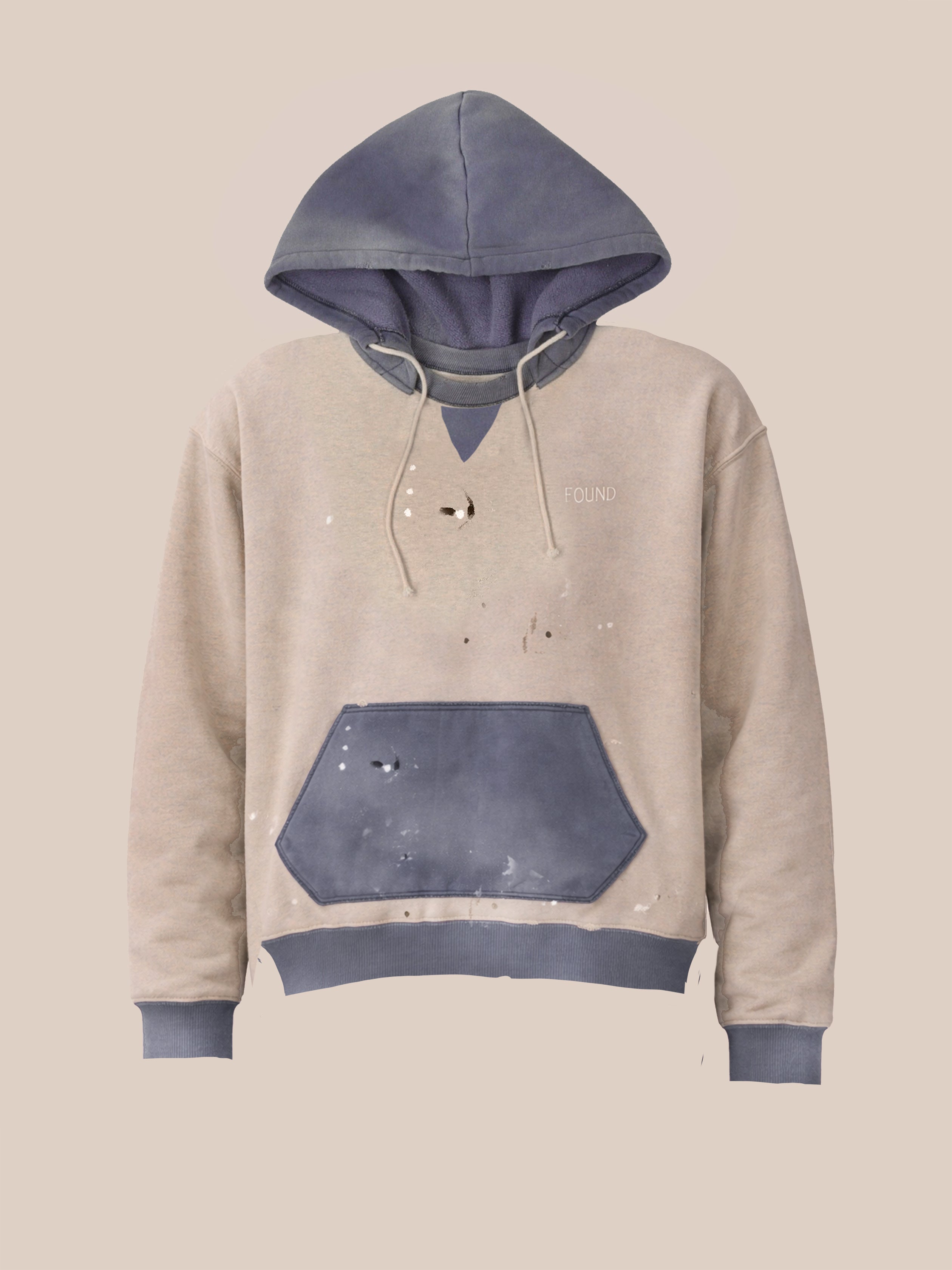 The FOUND Two-Tone Painter Hoodie in beige and blue features stains, holes, and distressing, shown against a plain light background.