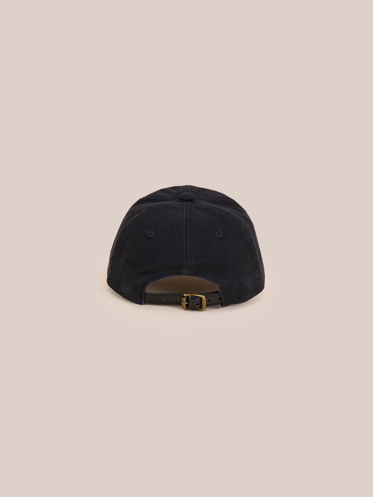 The Found Vintage Club Cap in black, shown from the back with vintage details and an adjustable metal buckle strap, set against a plain beige background.