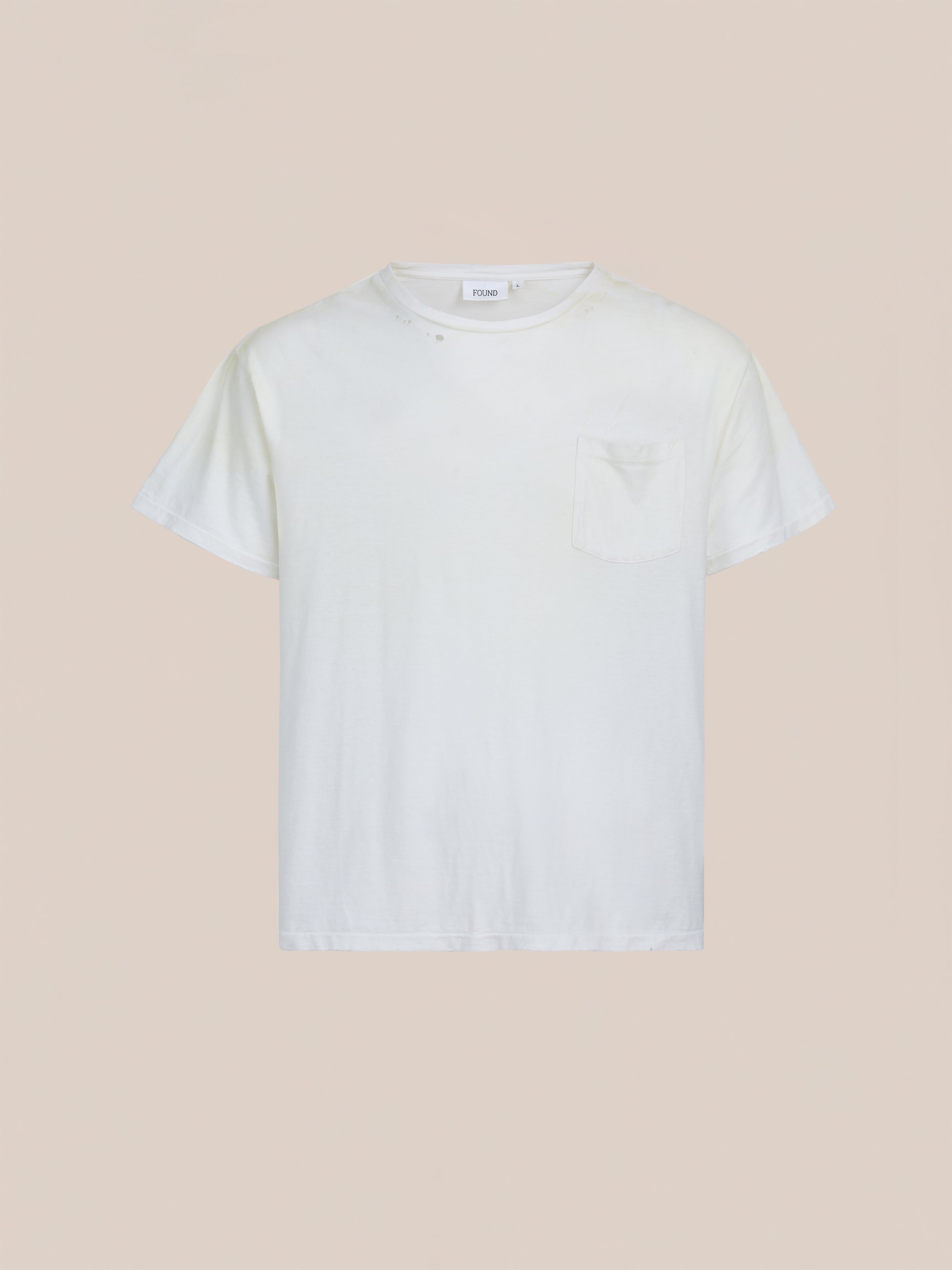 FOUND's Weathered Pocket Tee—a plain white, short-sleeve vintage-style shirt with a chest pocket—is shown against a neutral background.