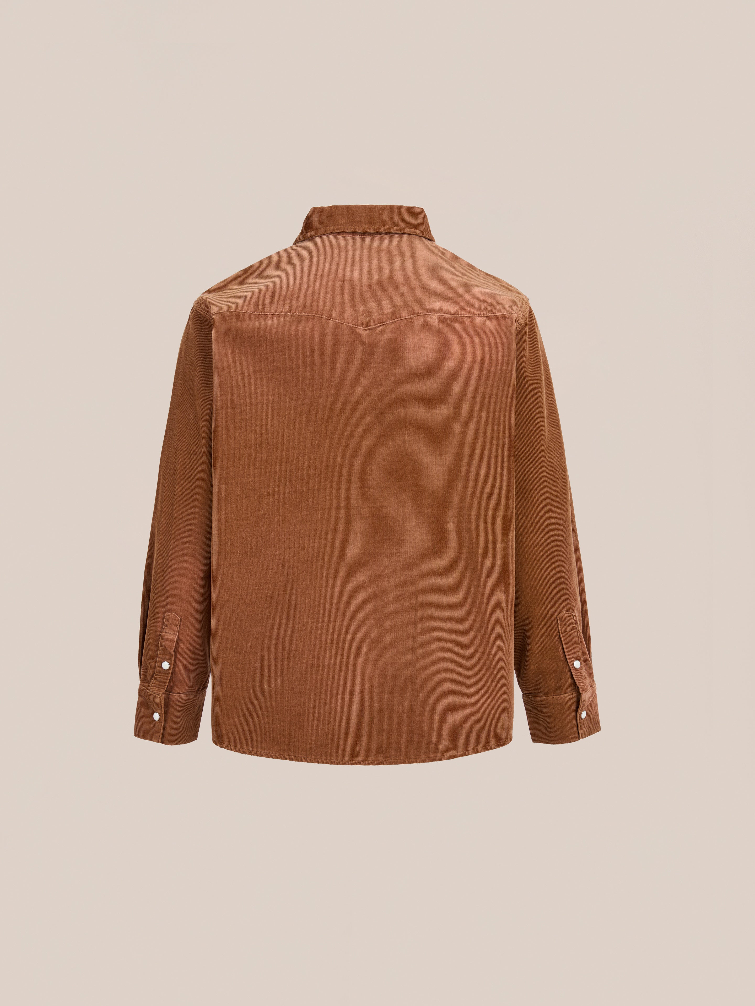 Back view of the FOUND Western Corduroy Shirt, featuring a collar and buttoned cuffs in a relaxed unisex fit, shown against a plain beige background.