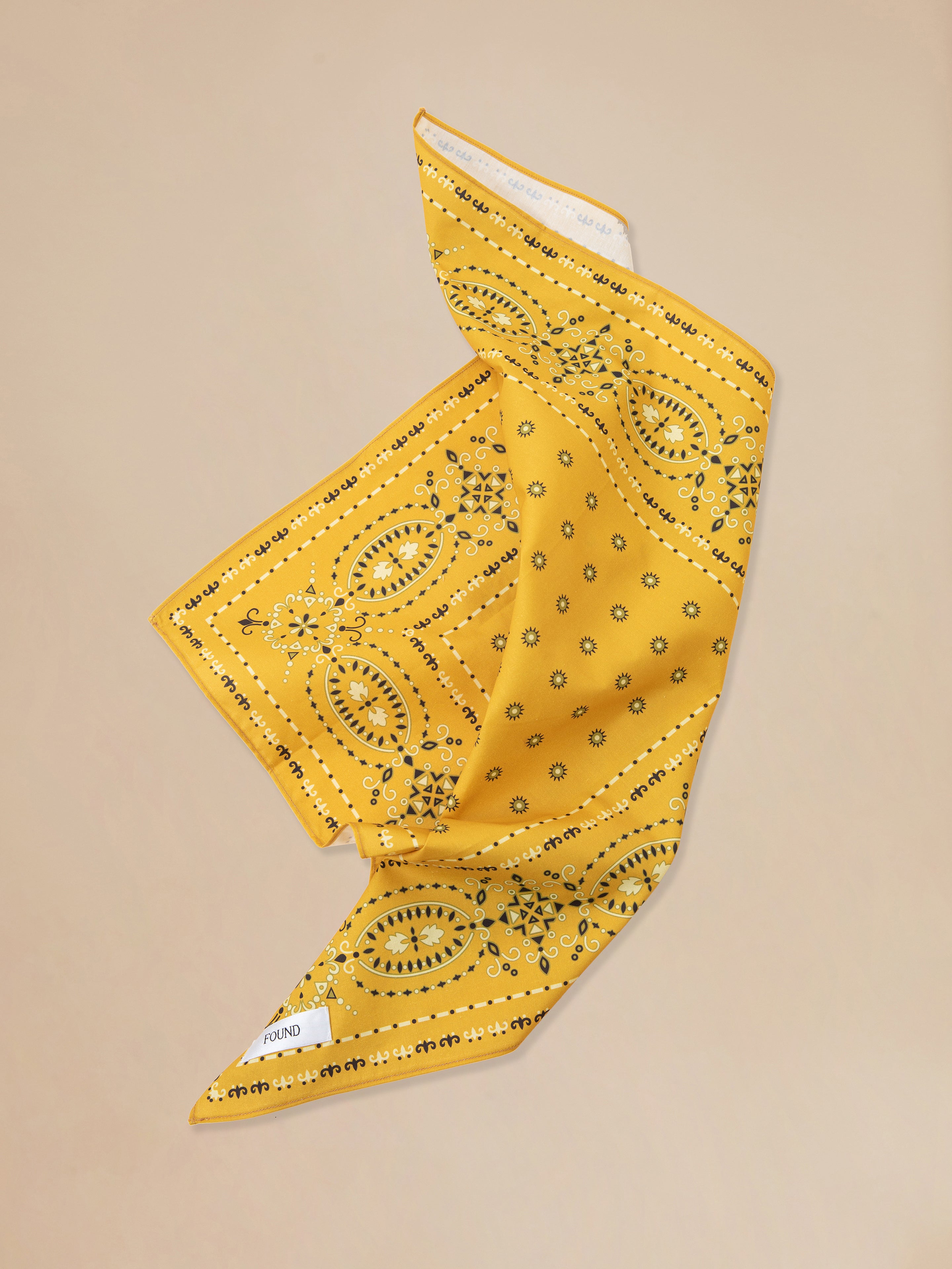 A Yellow Western bandana from Found on a beige background.