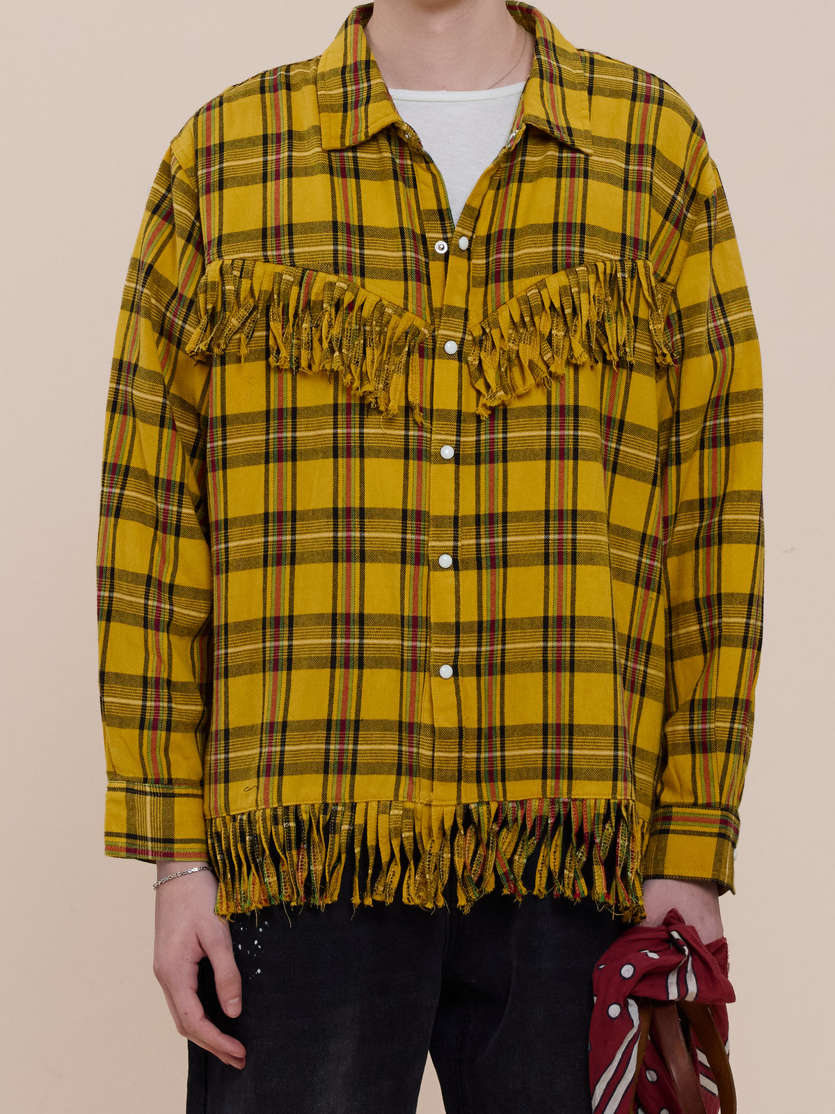 Person wearing the FOUND High Plains Fringe Shirt in yellow plaid with chest and hem details, standing against a neutral background.