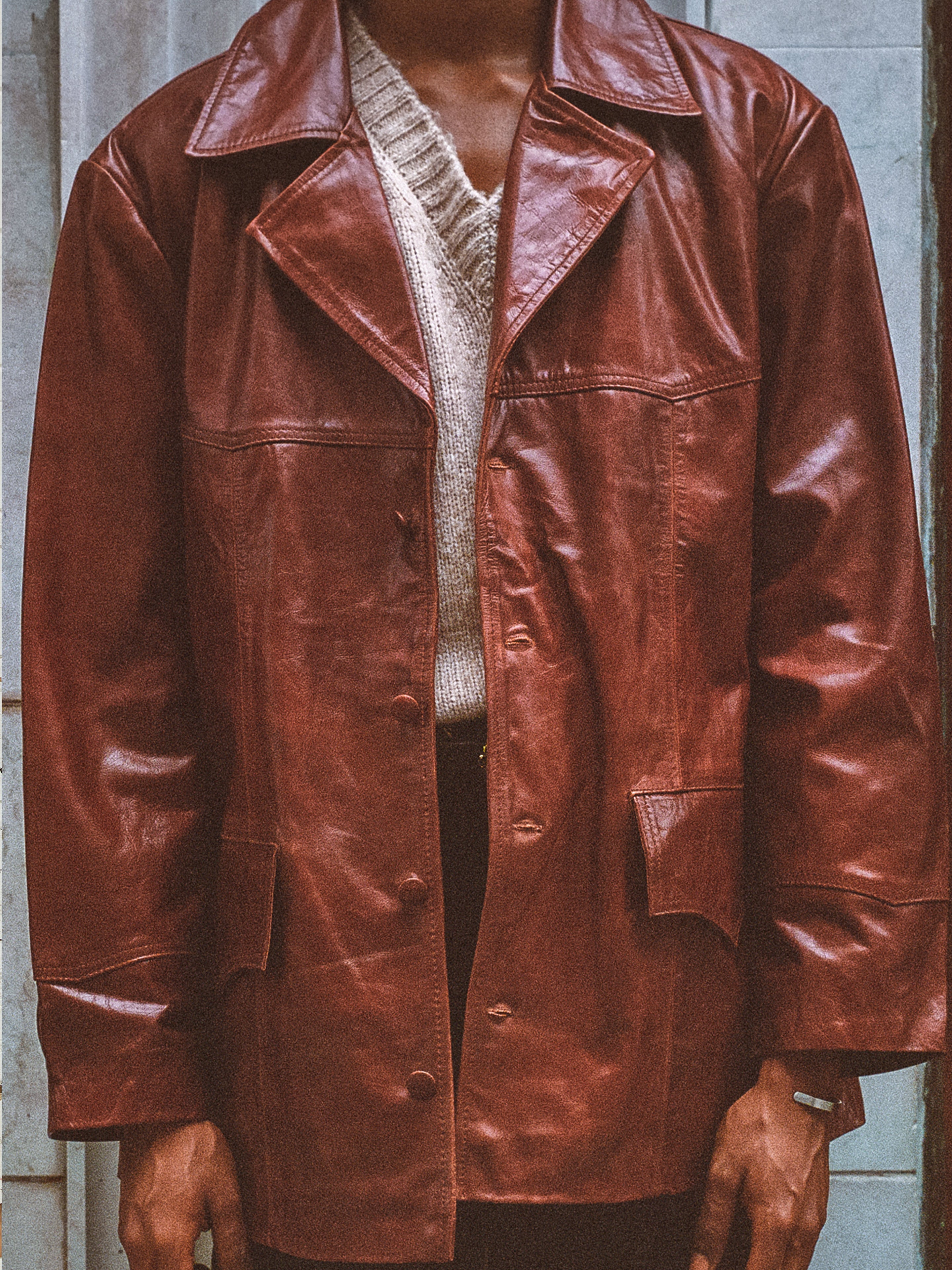 A person wears the FOUND Claret Western Oversized Leather Blazer over a beige knit sweater, standing against a neutral background.