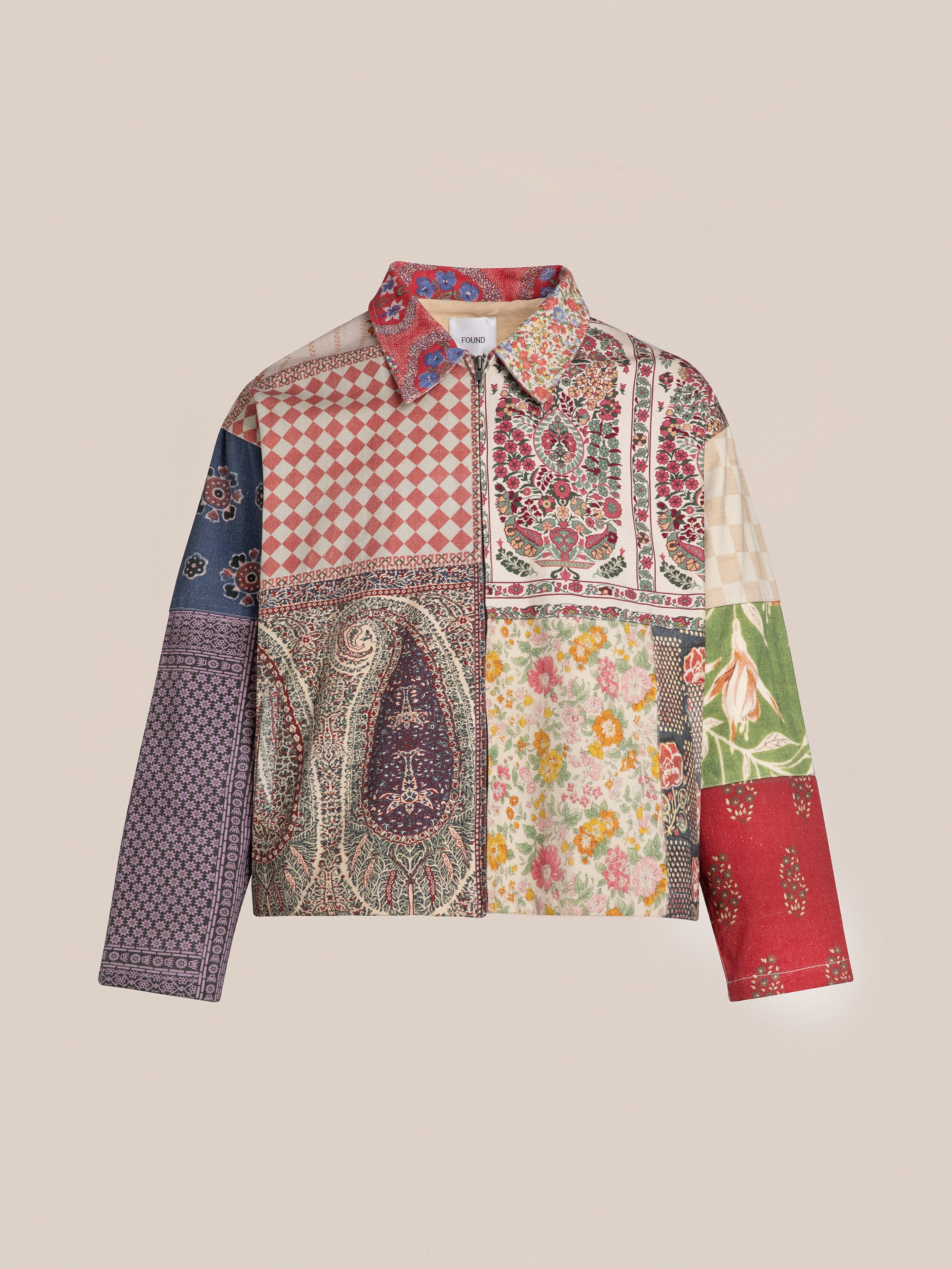 The FOUND Tapestry Twill Jacket offers a vintage aesthetic with its multi-colored floral and geometric patterns inspired by South Asian designs, complete with a collar and front zipper.