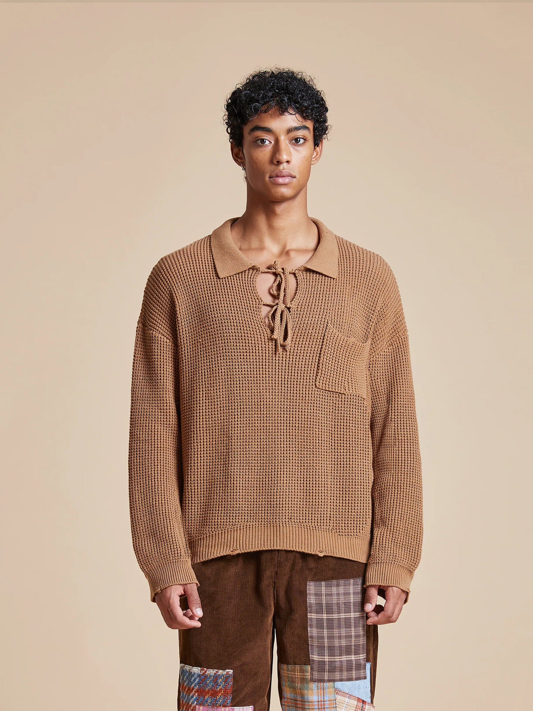 A man wearing a cozy Found Tie-Collar Knit Sweater in autumn.