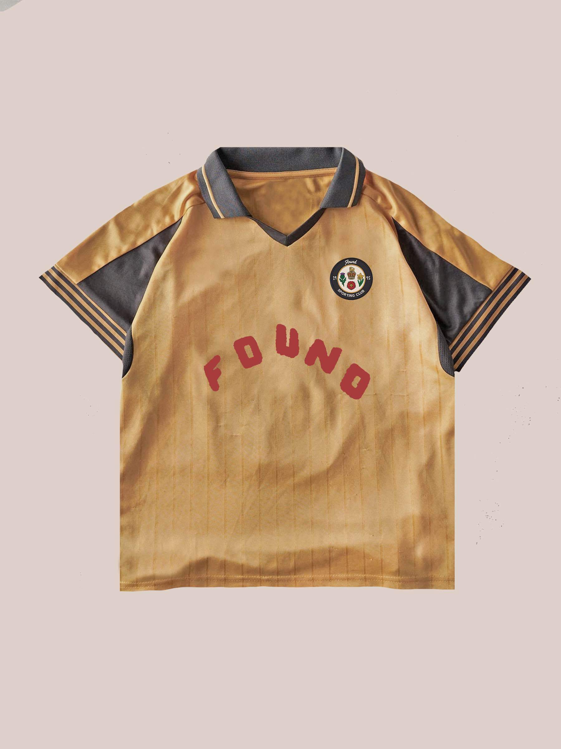 The Rosewood Jersey by FOUND is a unisex gold and black soccer top with short sleeves, "FOUND" in red, and a circular crest on the left chest, shown against a plain light background.