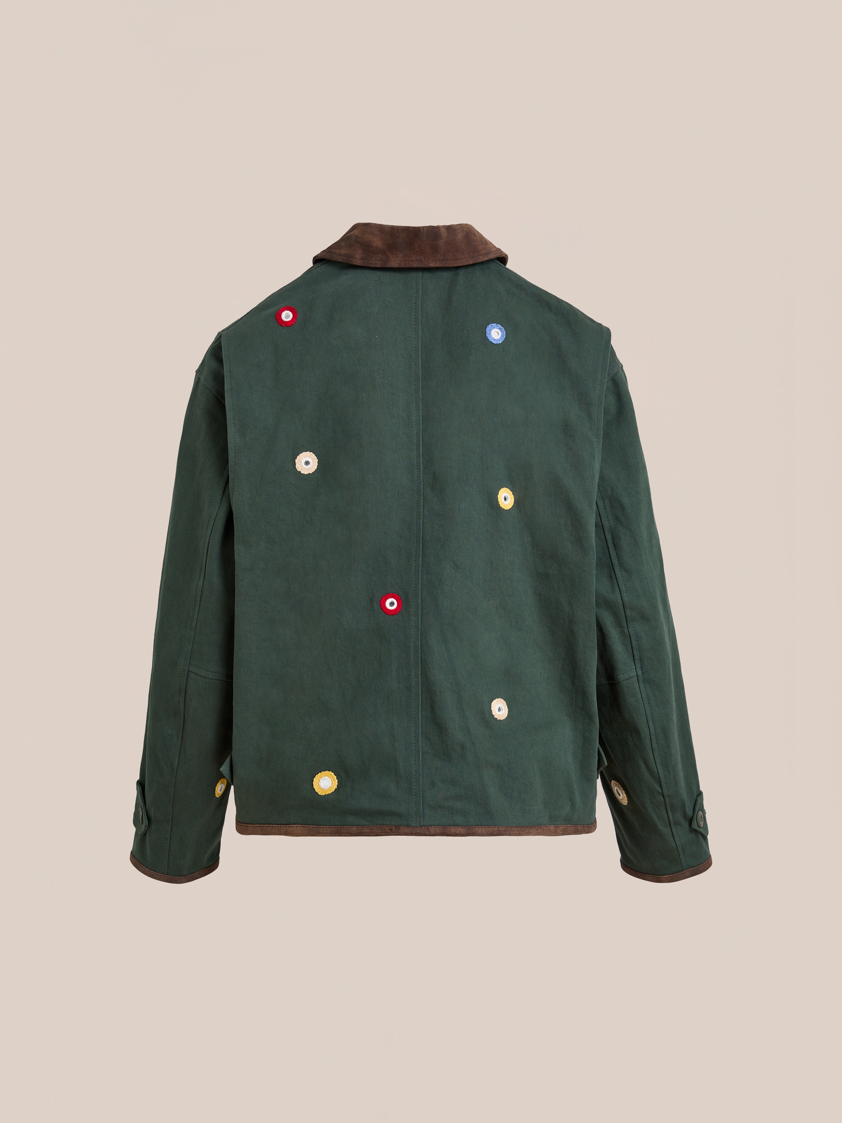 The Hand Embroidered Mirror Abhala Jacket by Found is a handcrafted cotton twill jacket in dark green, with a brown collar and cuffs, shown from the back, featuring colorful circular patches and Sheesha Kari-inspired mirror embroidery.