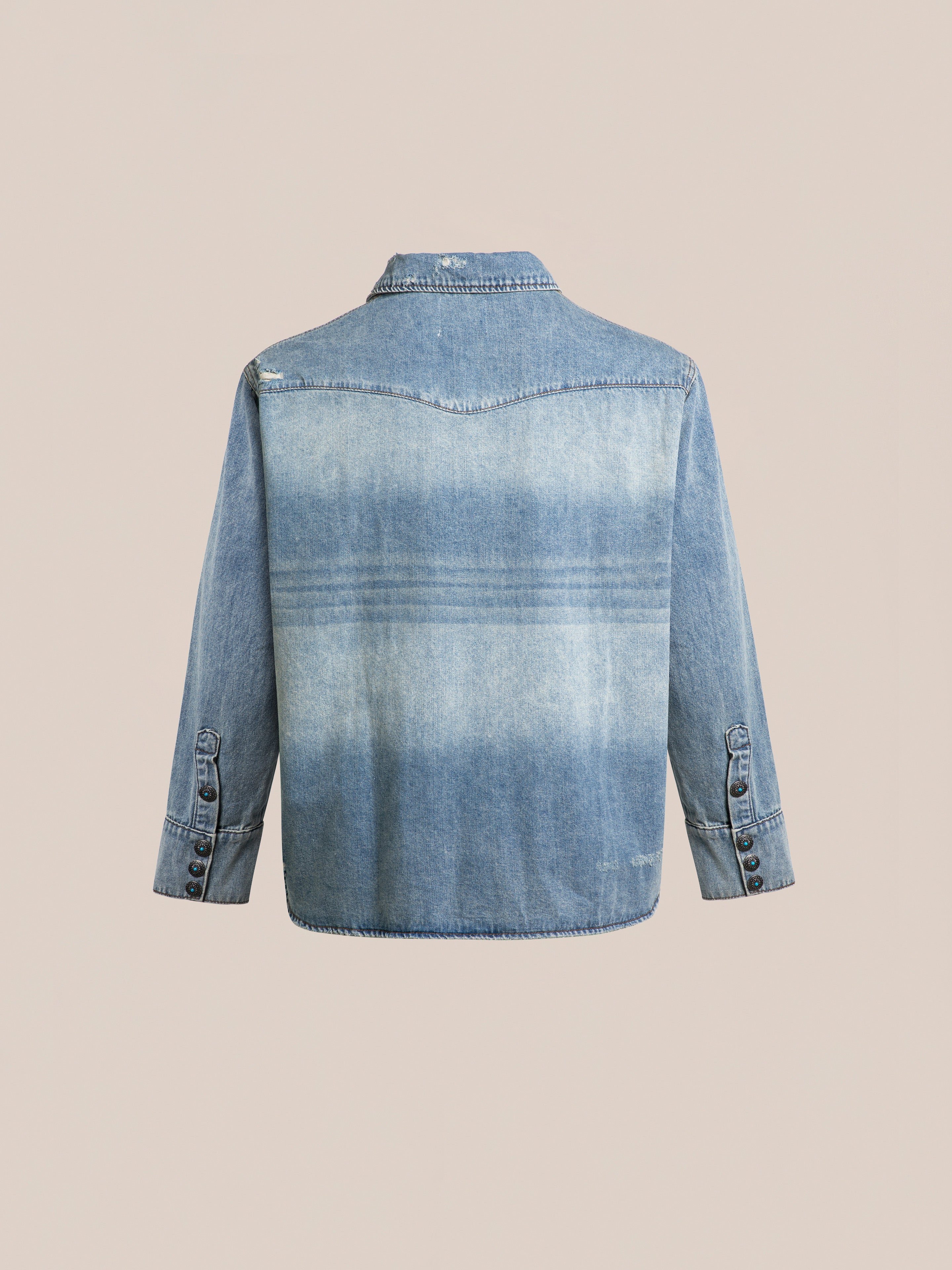 Back view of the FOUND Bouquet Floral Embroidered Western Denim Shirt in light blue, featuring a relaxed fit, long sleeves with buttoned cuffs, and yoke detail across the shoulders.