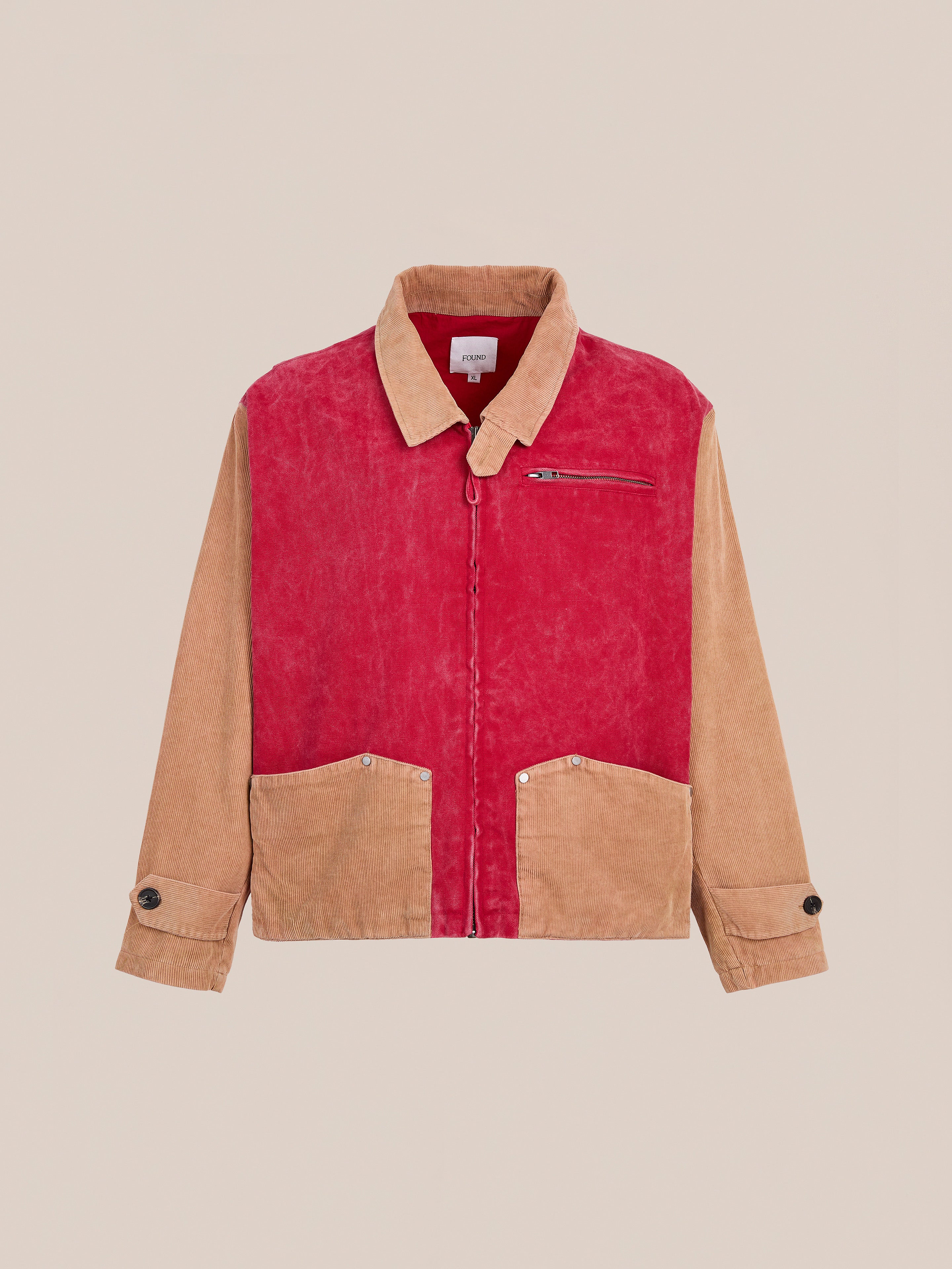 The Found Corduroy Field Jacket is a two-tone unisex workwear style with a red front, tan corduroy sleeves, collar, and pockets, plus a zippered chest pocket and front buttons.