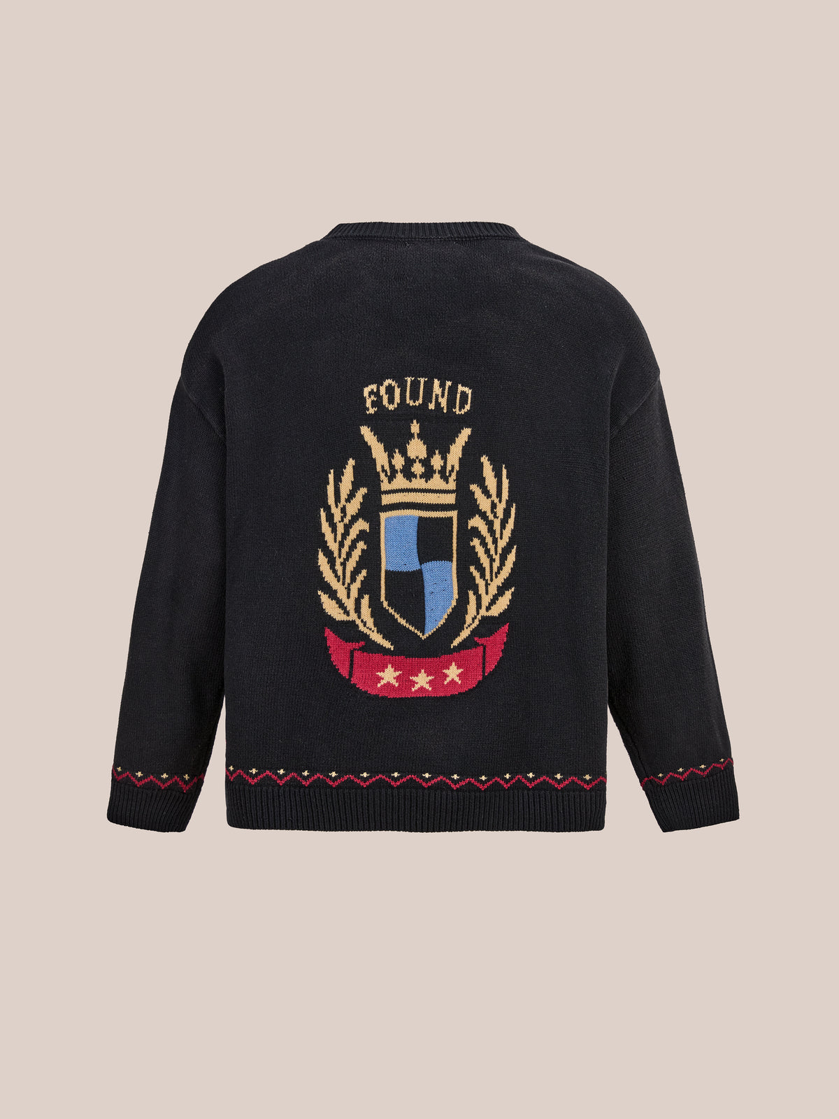 FOUND Crest Sweater: collegiate-inspired knit with gold crown and laurel motif, “FOUND” at top, red and gold varsity accents at hem and sleeves.