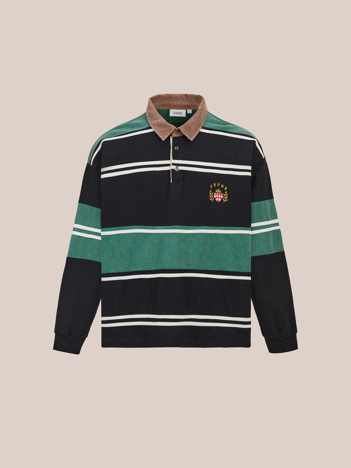 The FOUND Crestfield Rugby is a unisex shirt with green, black, and white stripes, brown collar, and an embroidered crest on the left chest for classic style.